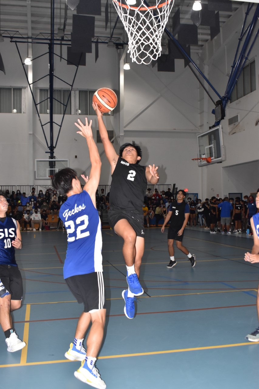 MHS' Raven Francisco extends for the finish over an SIS defender during an IT&E Interscholastic Boys High School Basketball League game  Friday at the MHS gym.