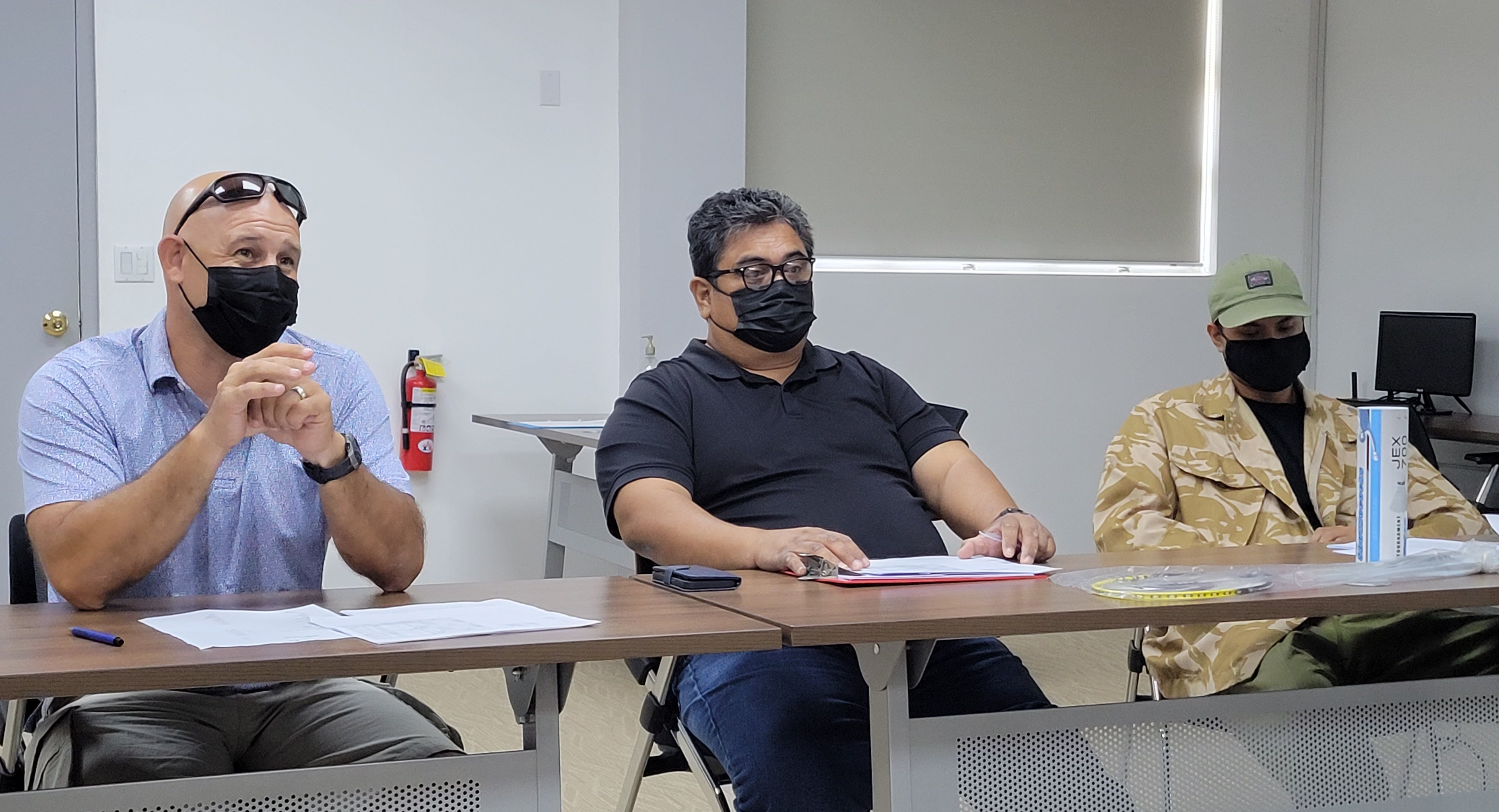 From left, Public School System Athletic Program director Nick Gross and staff Lawrence Camacho and Joshua Andrew attend a meeting with Northern Marianas Badminton Association officials to discuss the schedule for the inaugural TakeCare Insurance Interscholastic Badminton League last week in the Gilbert C. Ada Gymnasium conference room.