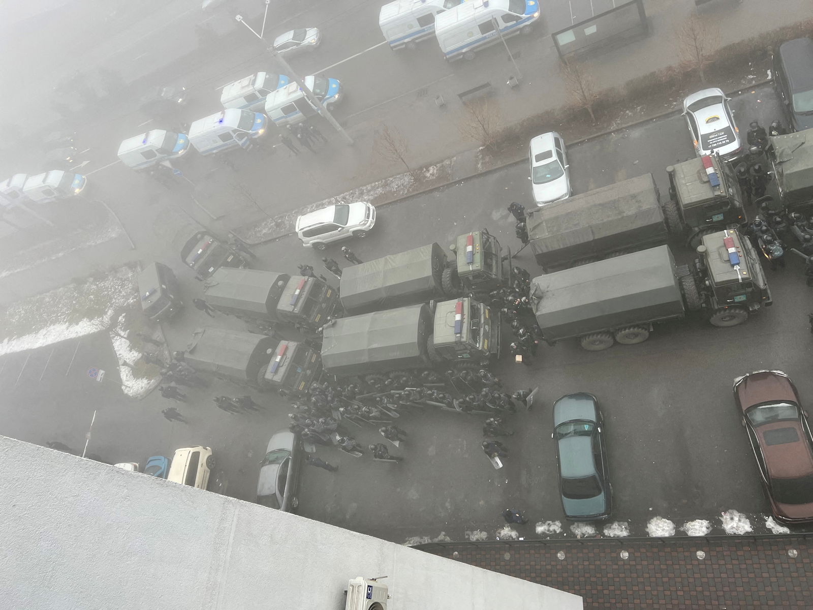 A demonstrator carries a police shield in front of police line during a protest in Almaty, Kazakhstan, Wednesday, Jan. 5, 2022.