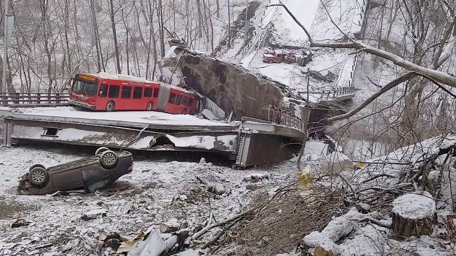 Damaged vehicles are seen at the scene of a collapsed bridge in Pittsburgh, Pennsylvania, Jan. 28, 2022, in this image obtained from a social media video.