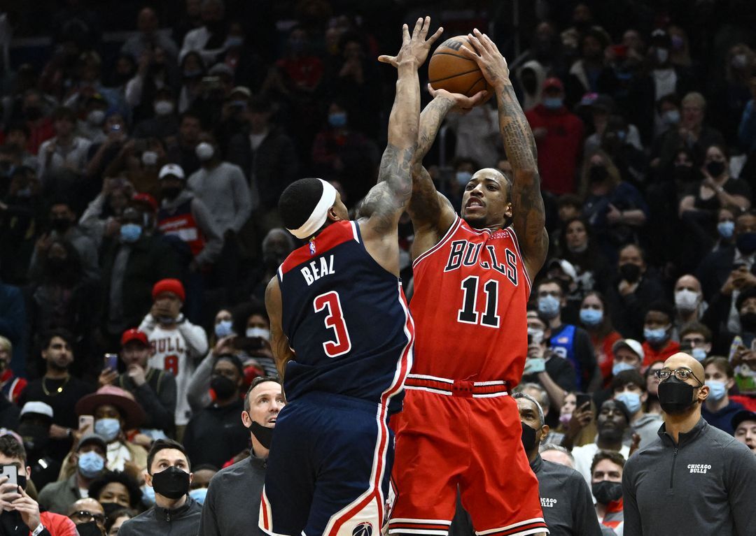 Chicago Bulls forward DeMar DeRozan (11) hits a game winning three point shot over Washington Wizards guard Bradley Beal (3) during the second half at Capital One Arena in Washington, D.C. on Jan. 1, 2022.Photo by Brad Mills-USA TODAY Sports