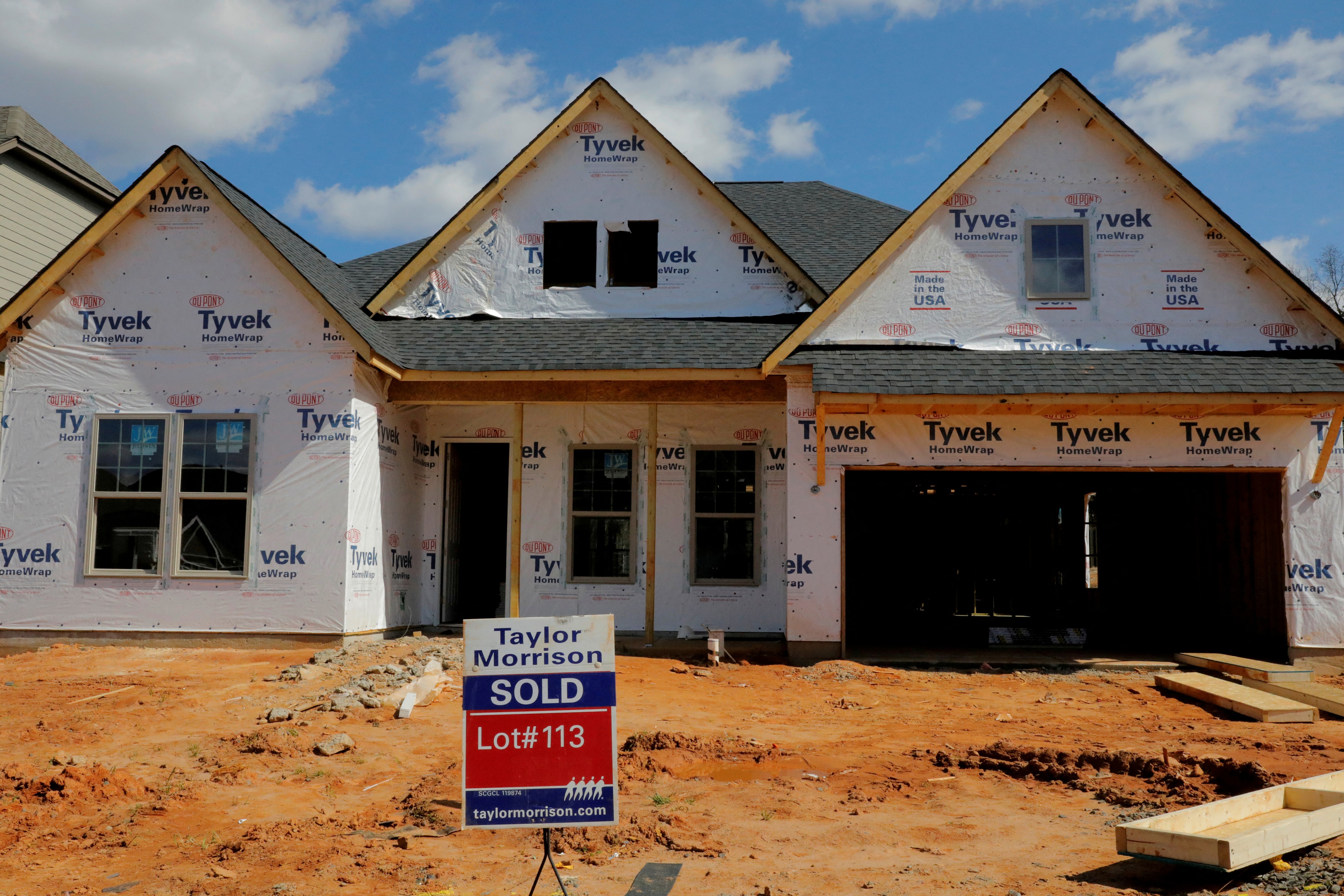 A home under construction stands behind a "sold" sign in a new development in York County, South Carolina, Feb. 29, 2020.