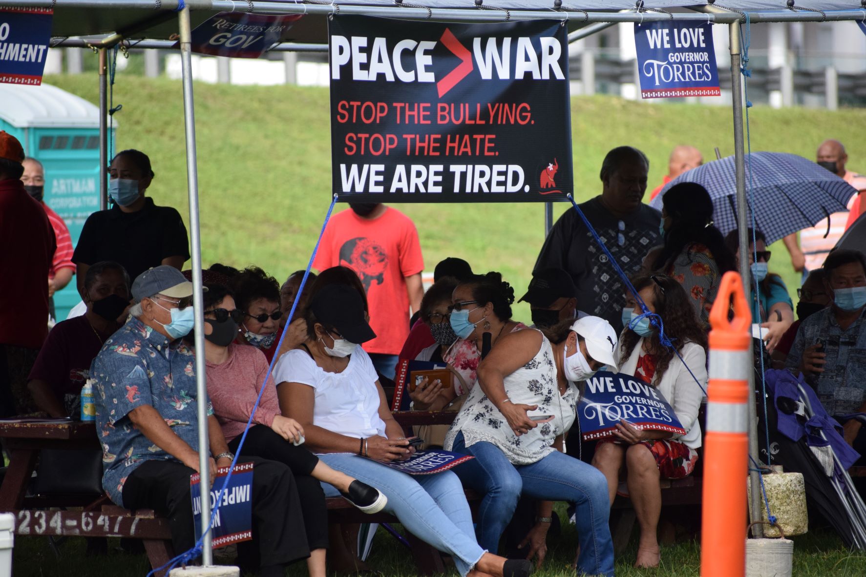 The family members of Gov. Ralph DLG Torres and other supporters are seen at a canopy near the legislative building on Capital Hill.