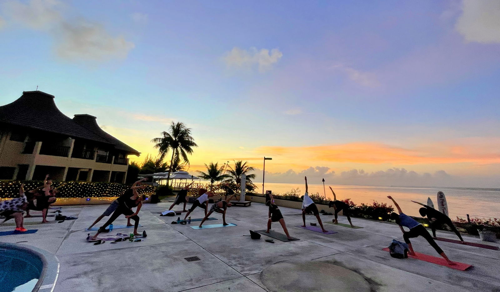 Participants perform a stretching exercise during sunset yoga.