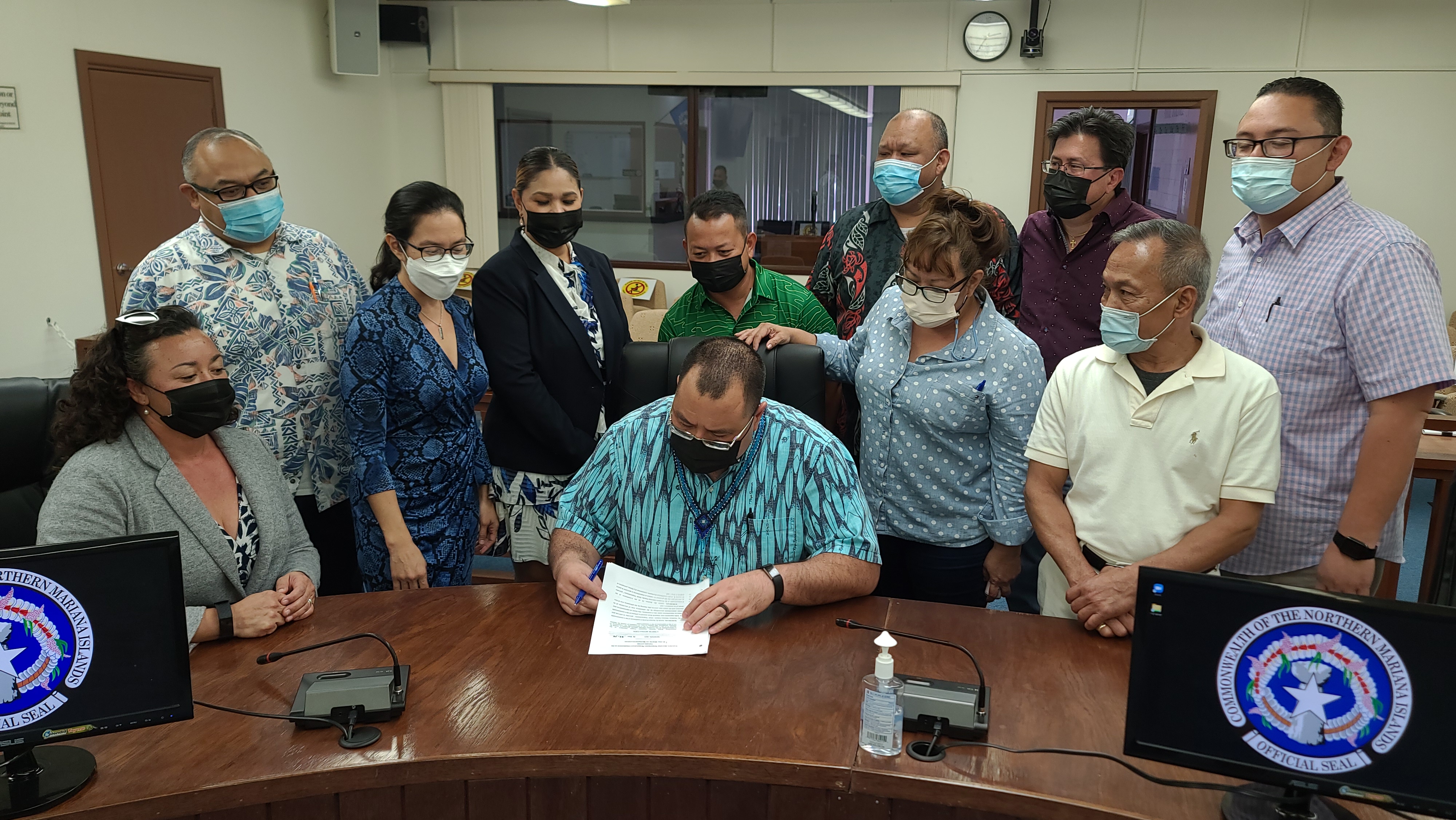 House members look on as  Speaker Edmund S. Villagomez reads the bipartisan legislation they have co-sponsored to fund bonuses for  CNMI retirees and propose local stimulus initiatives. 