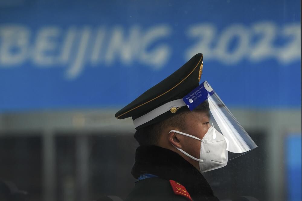 A Chinese paramilitary policeman wearing a face shield and mask to protect from the coronavirus stands guard at an entrance gate to a barricaded Main Press Center for the Winter Olympic Games in Beijing, Wednesday.