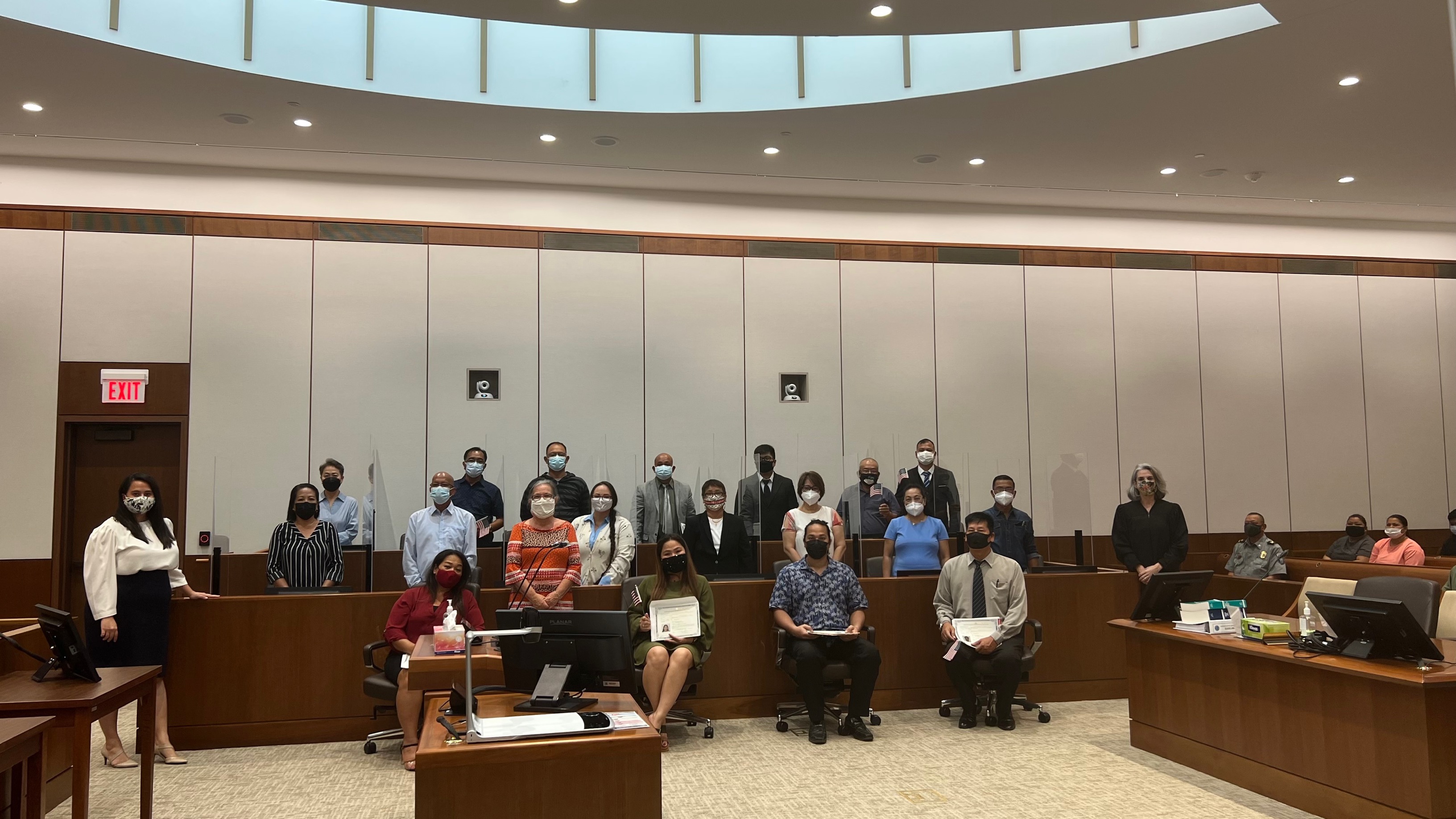 Seventeen new U.S. citizens  sworn in  Tuesday afternoon pose for a photo with Magistrate Judge Heather Kennedy of the District Court for the NMI, USCIS immigration officer Patricia Phelan, and District Court for the NMI law clerk Gretchen A. Smith.