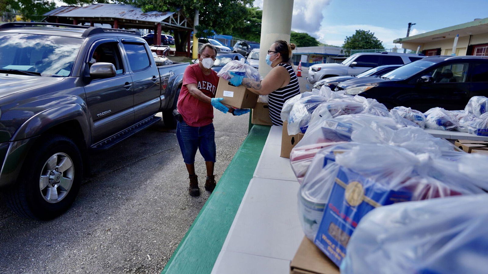 Staff from the Agana Heights Mayor's Office and members of AmeriCorps distribute bags of groceries and fruits in this Nov. 5, 2021 file photo.
