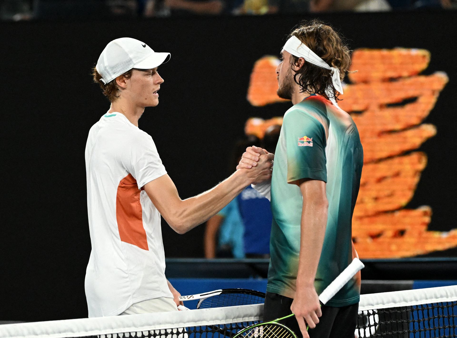 Greece's Stefanos Tsitsipas and Italy's Jannik Sinner shake hands after their quarter-final match Wednesday.
