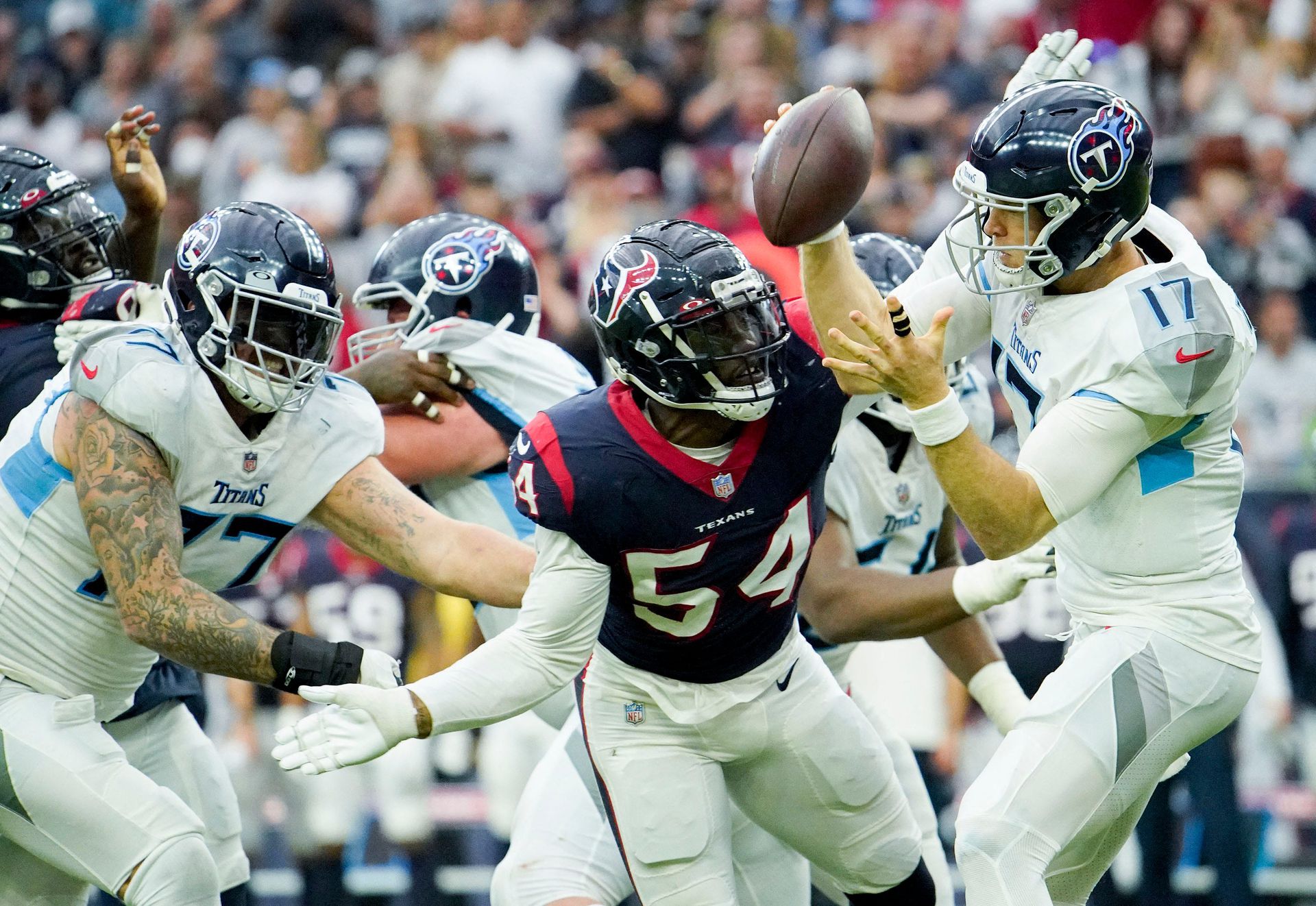 Tennessee Titans quarterback Ryan Tannehill (17) is pressured by Houston Texans defensive end Jacob Martin (54) during the fourth quarter at NRG Stadium in Houston on Jan. 9, 2022.