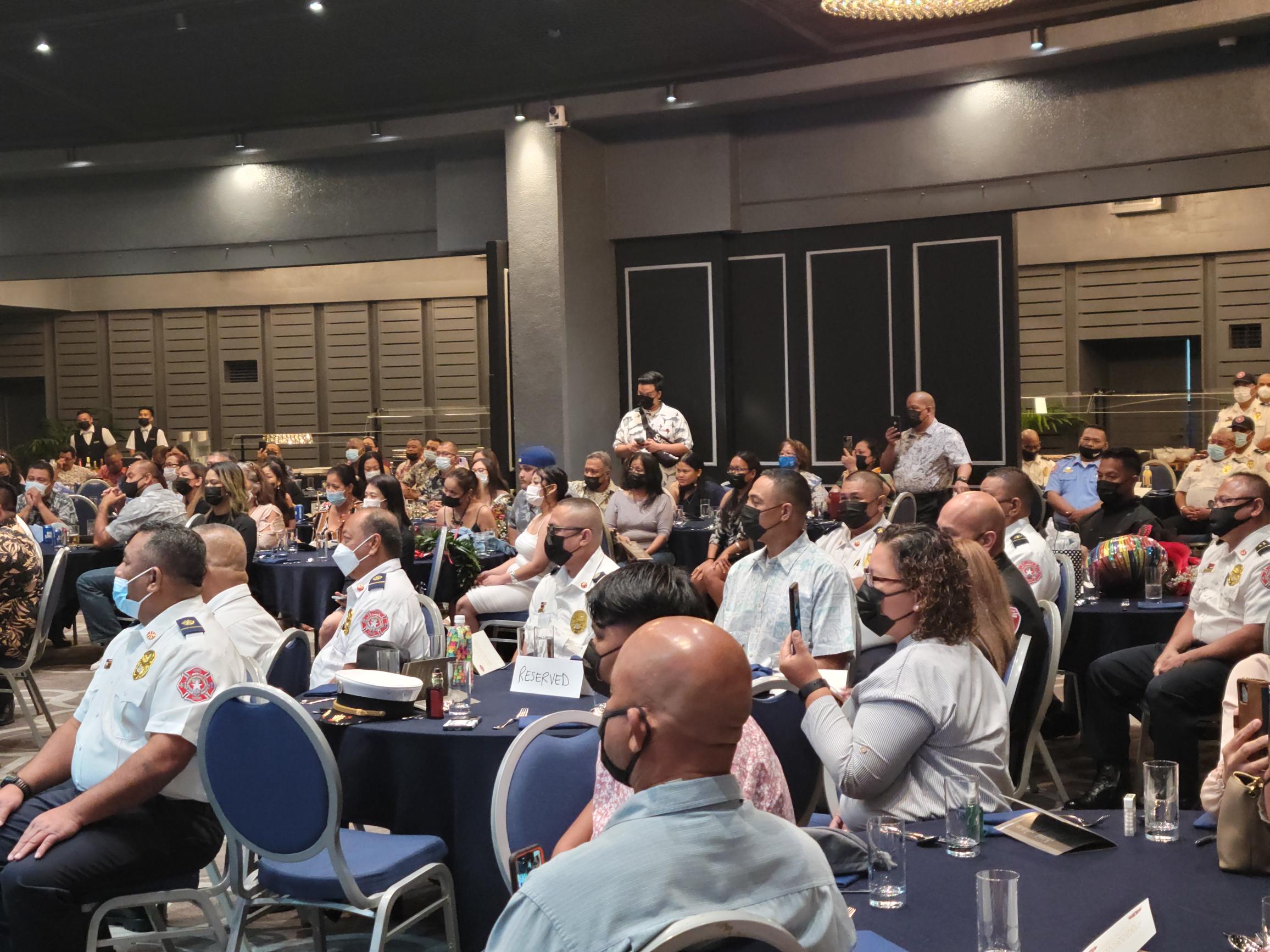 Fire chief Dennis Mendiola and deputy fire chief Jesse C. Mesa are seated at a table with other fire department officials as they listen to a speaker during the 14th Fire Academy graduation ceremony on Jan. 7, 2022 in Kensington Hall.