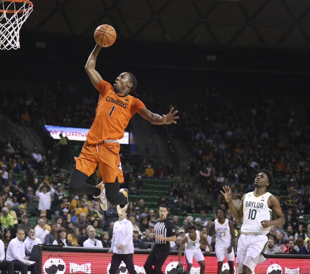 Oklahoma State guard Bryce Thompson scores over Baylor guard Adam Flagler (10) in the first half of an NCAA college basketball game, Saturday, in Waco, Texas.