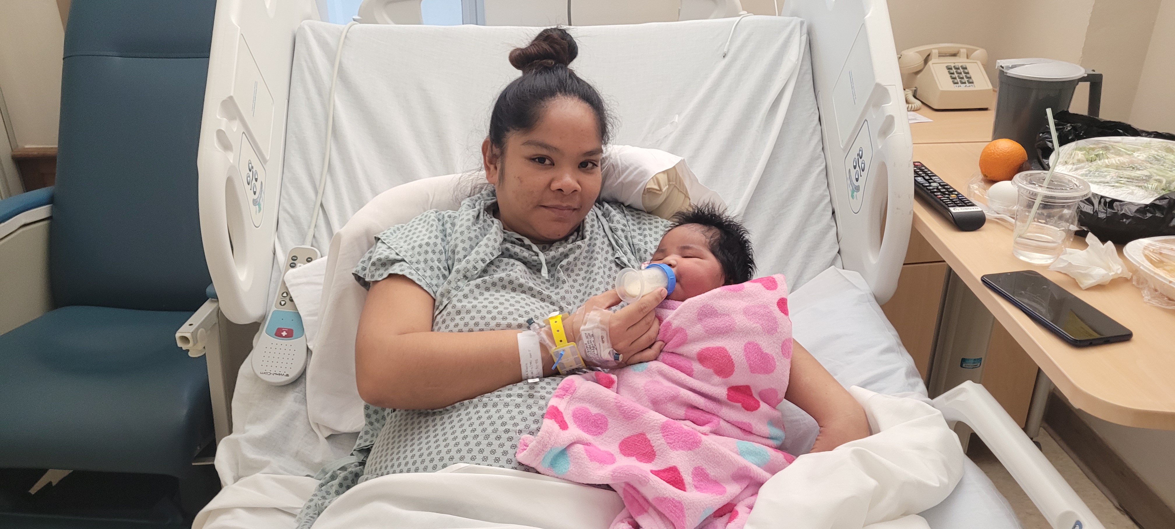 Baby girl Princess Jane Gaza Sanchez is held by her mother, 30-year-old Nicole Sanchez of Dandan, in a recovery room of the Commonwealth Health Center, Sunday.