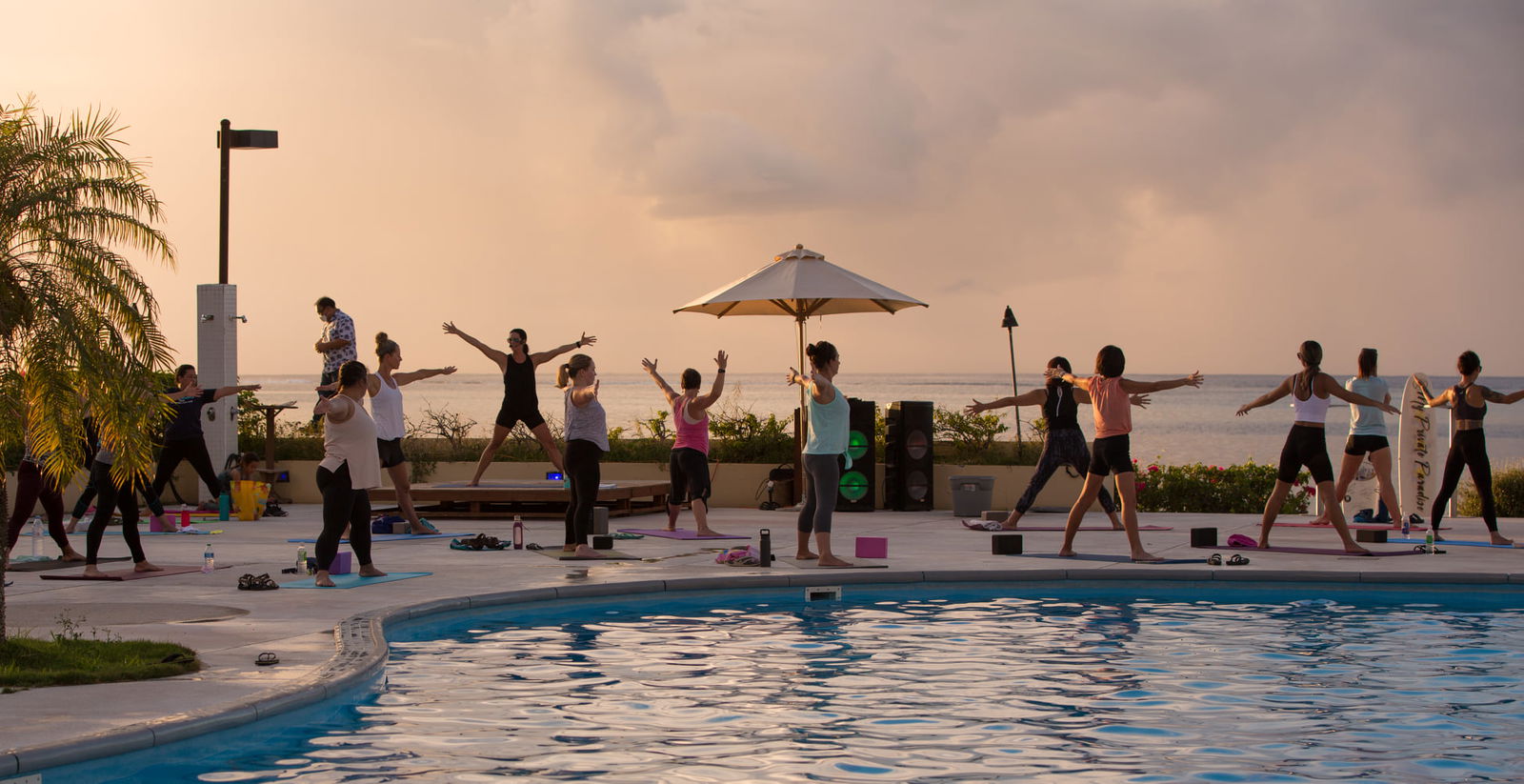The Class & Glass sunset yoga class at the Aqua Resort Club poolside.