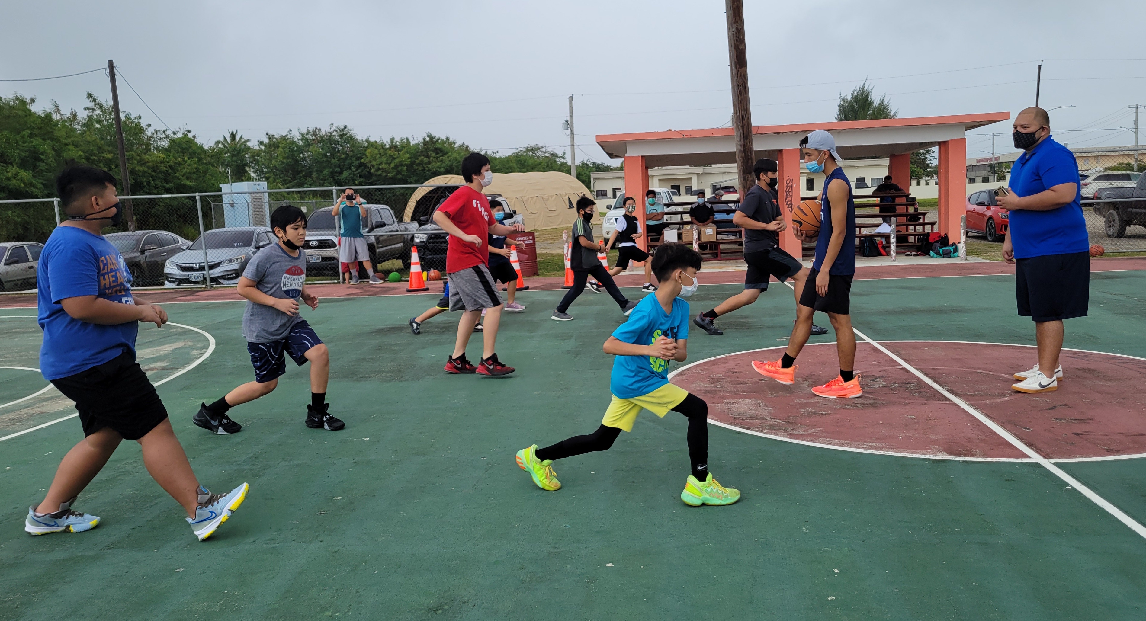Participants in the “Bola” kick-off session perform warm-up drills at the Koblerville Basketball Court on Saturday.