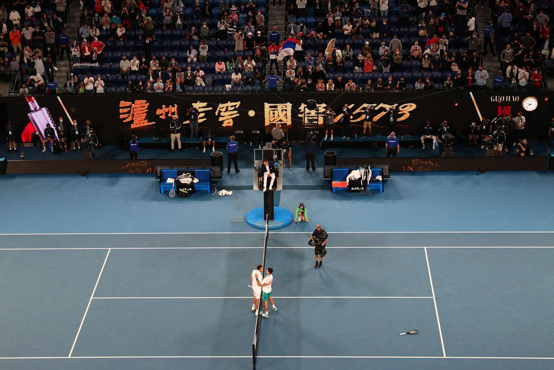 Russia's Daniil Medvedev and Serbia's Novak Djokovic meet at the net after their final match at Melbourne Park, Melbourne, Australia on Feb. 21, 2021.
