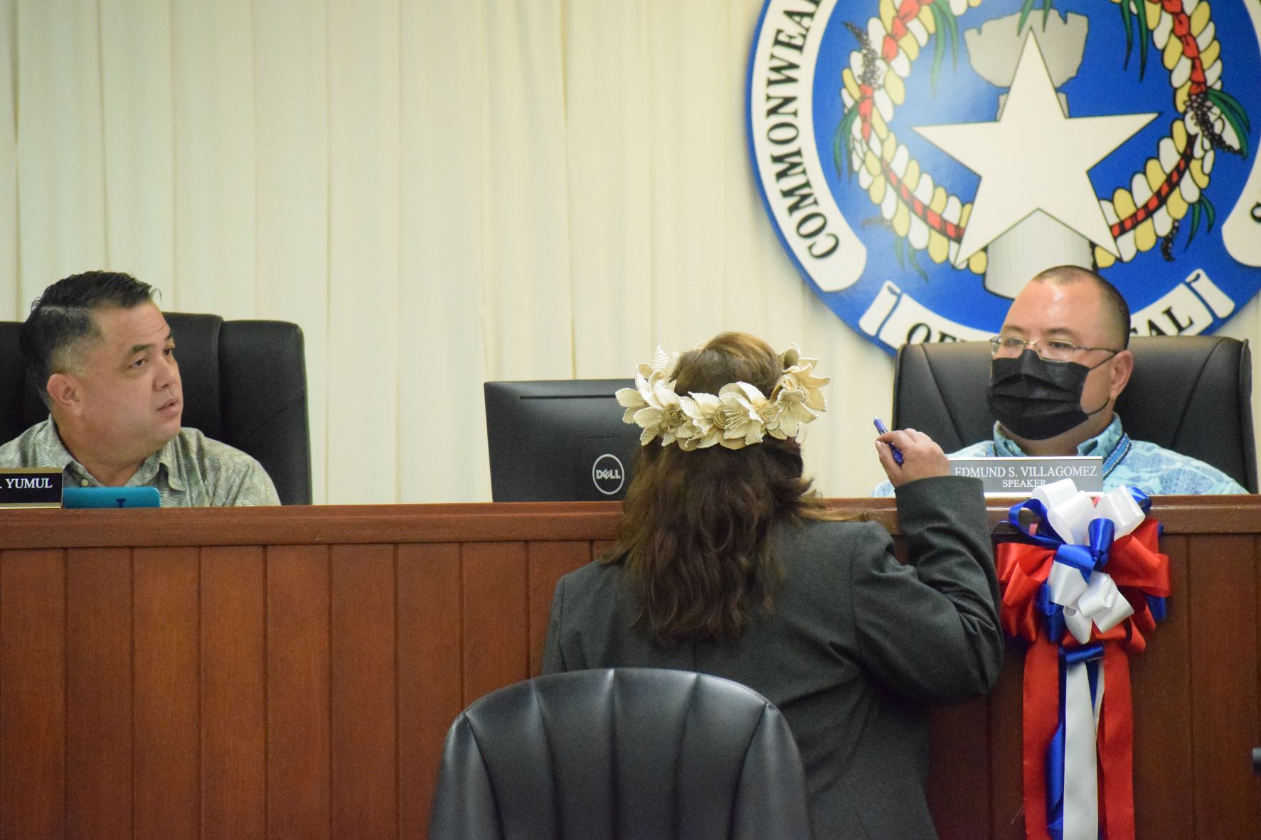 House Floor Leader Ralph Yumul, left, and Vice Speaker Blas Jonathan Attao listen to Rep. Celina Babauta, back to the camera, during a break from the House session on Wednesday.