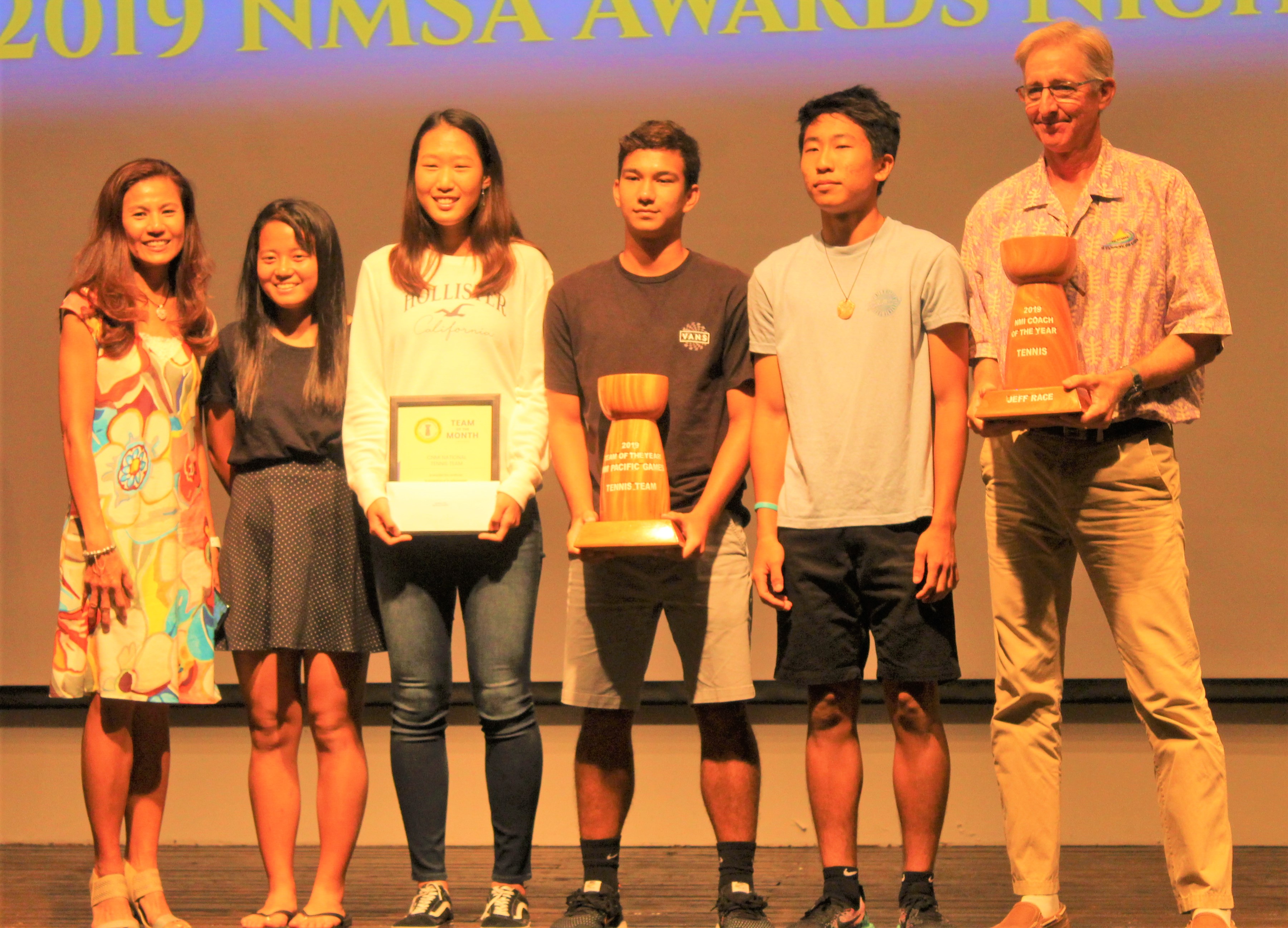 From left, tennis players Lydia Tan, Malika Miyawaki, Carol Lee, Robbie Schorr, Ken Song and coach Jeff Race pose for a photo during the 2019 Northern Marianas Sports Association awards ceremony at the Fiesta Resort & Spa in January 2020.