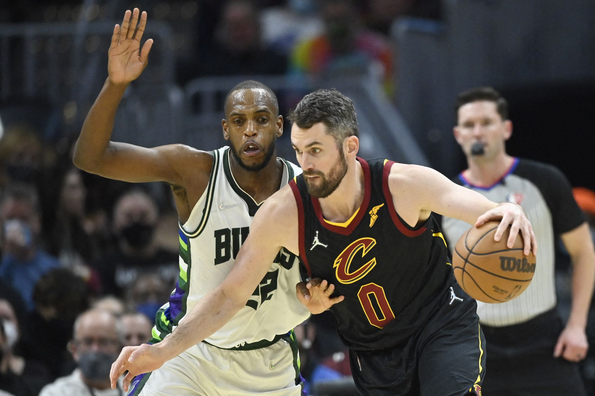 Milwaukee Bucks forward Khris Middleton (22) defends Cleveland Cavaliers forward Kevin Love (0) in the third quarter at Rocket Mortgage FieldHouse in Cleveland, Ohio on Jan. 26, 2022.