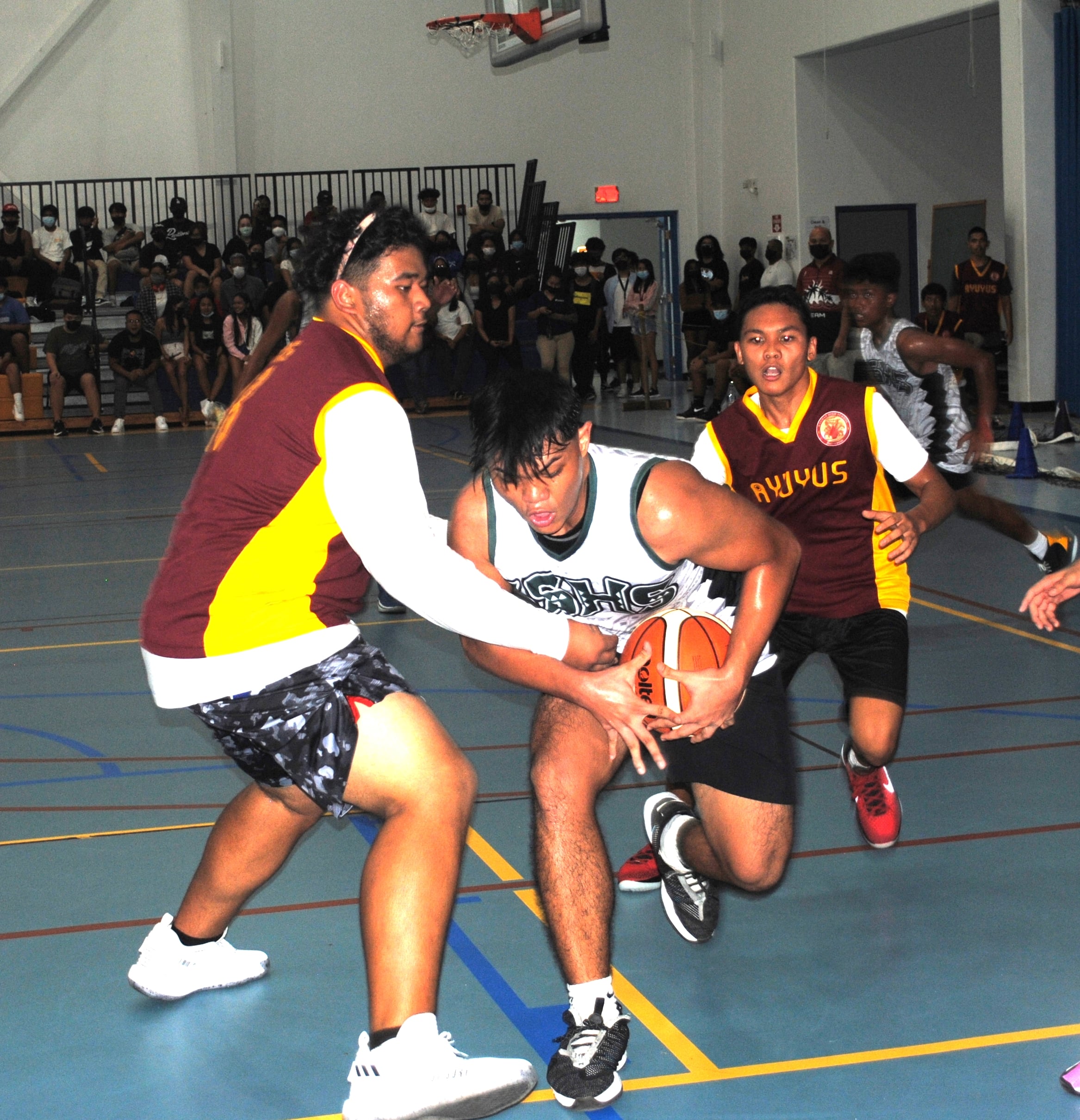 SSHS' Emanuel Feria protects the ball as defenders close in during an IT&E Interscholastic Boys High School Basketball League game at the MHS gym on Jan. 21, 2022.