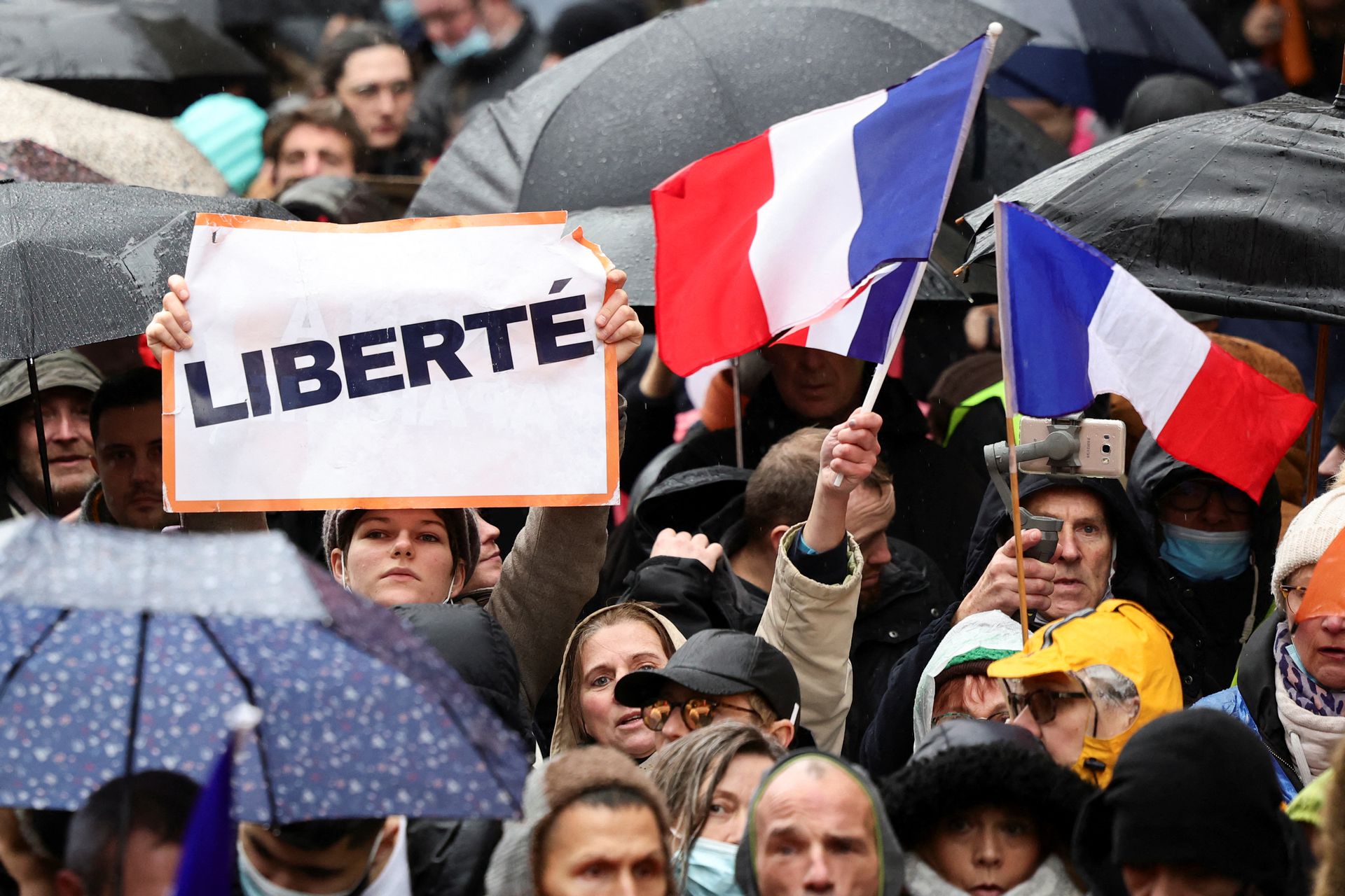 People attend a demonstration to protest against a bill that would transform France's current coronavirus disease health pass into a ''vaccine pass'' in Paris, France, Jan. 8, 2022. The banner reads: "Freedom."