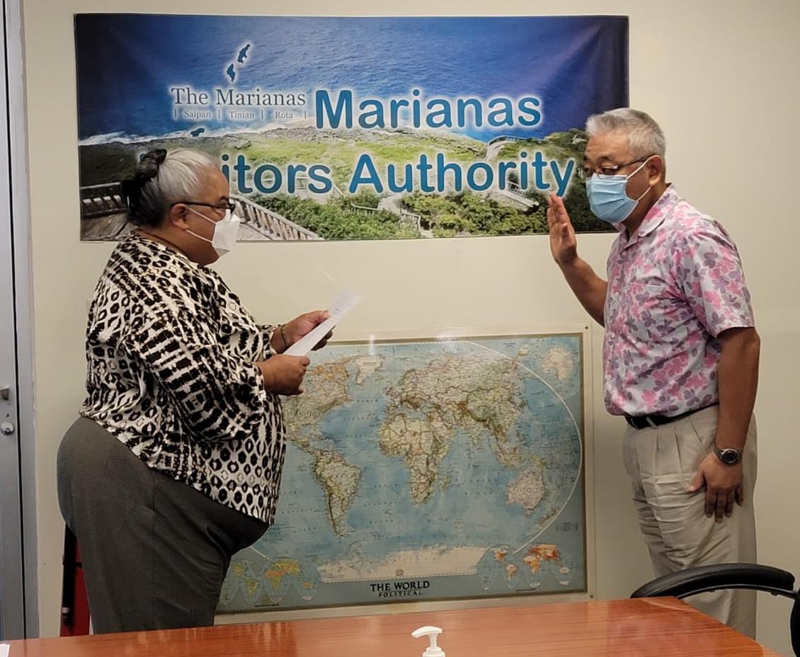 The Marianas Visitors Authority’s newest board member, PMT General Manager Masaru Sunaga, right, takes the oath of office administered by Board Chairwoman Viola Alepuyo on Dec. 27, 2021 at the MVA office in San Jose, Saipan.  