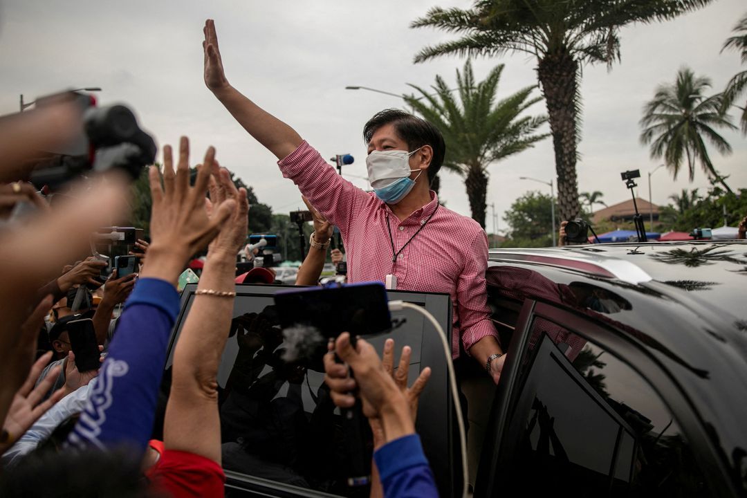Former Philippine Sen. Ferdinand Marcos Jr. waves to supporters after filing his certificate of candidacy for president in the 2022 national election, in Pasay City, Metro Manila on Oct. 6, 2021.