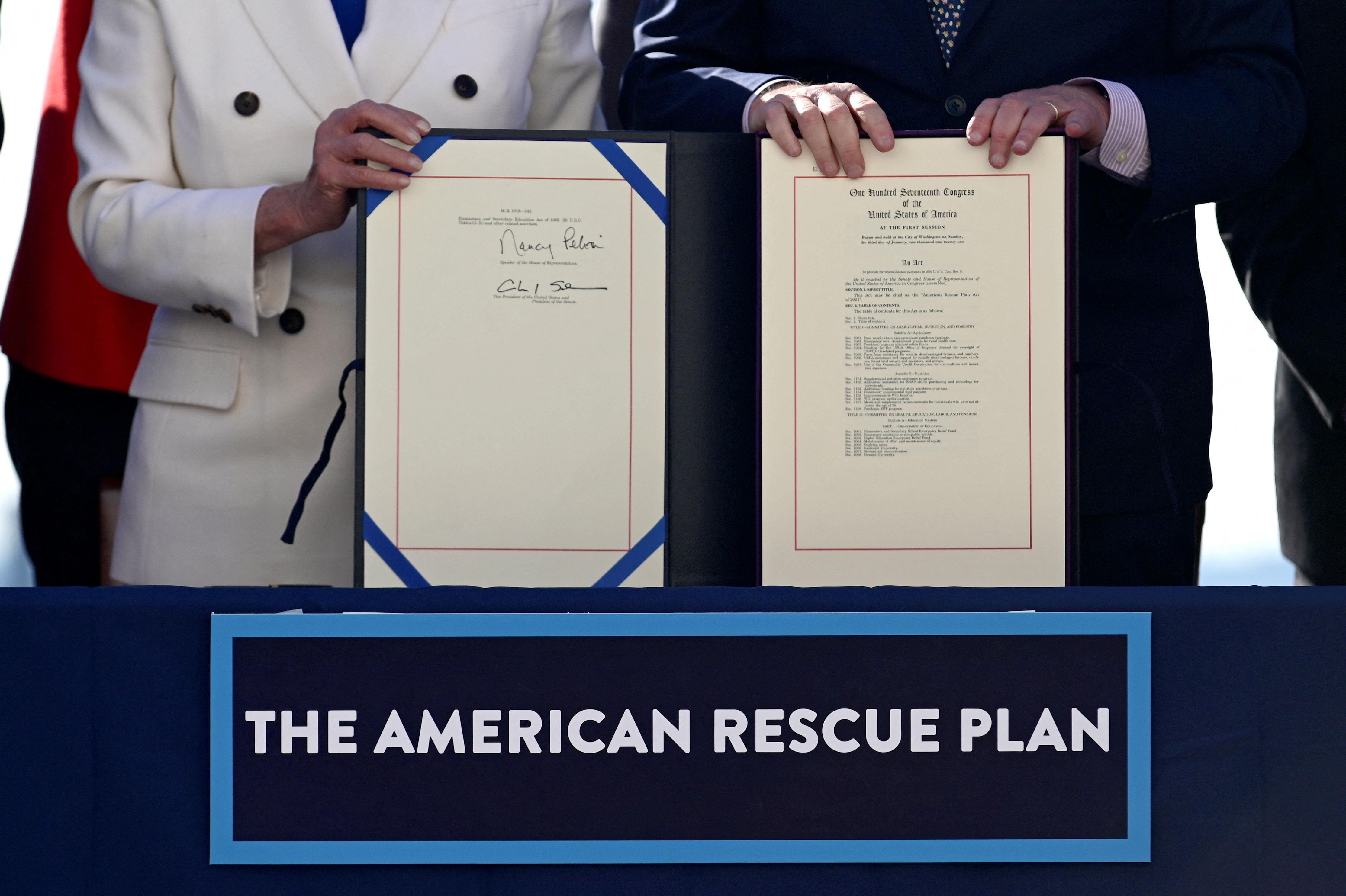 House Speaker Nancy Pelosi, D-Calif., and Senate Majority Leader Chuck Schumer, D-NY, display the "American Rescue Plan" during the enrolment ceremony following passage of President Joe Biden's $1.9 trillion coronavirus disease  relief bill on Capitol Hill in Washington, D.C., March 10, 2021.