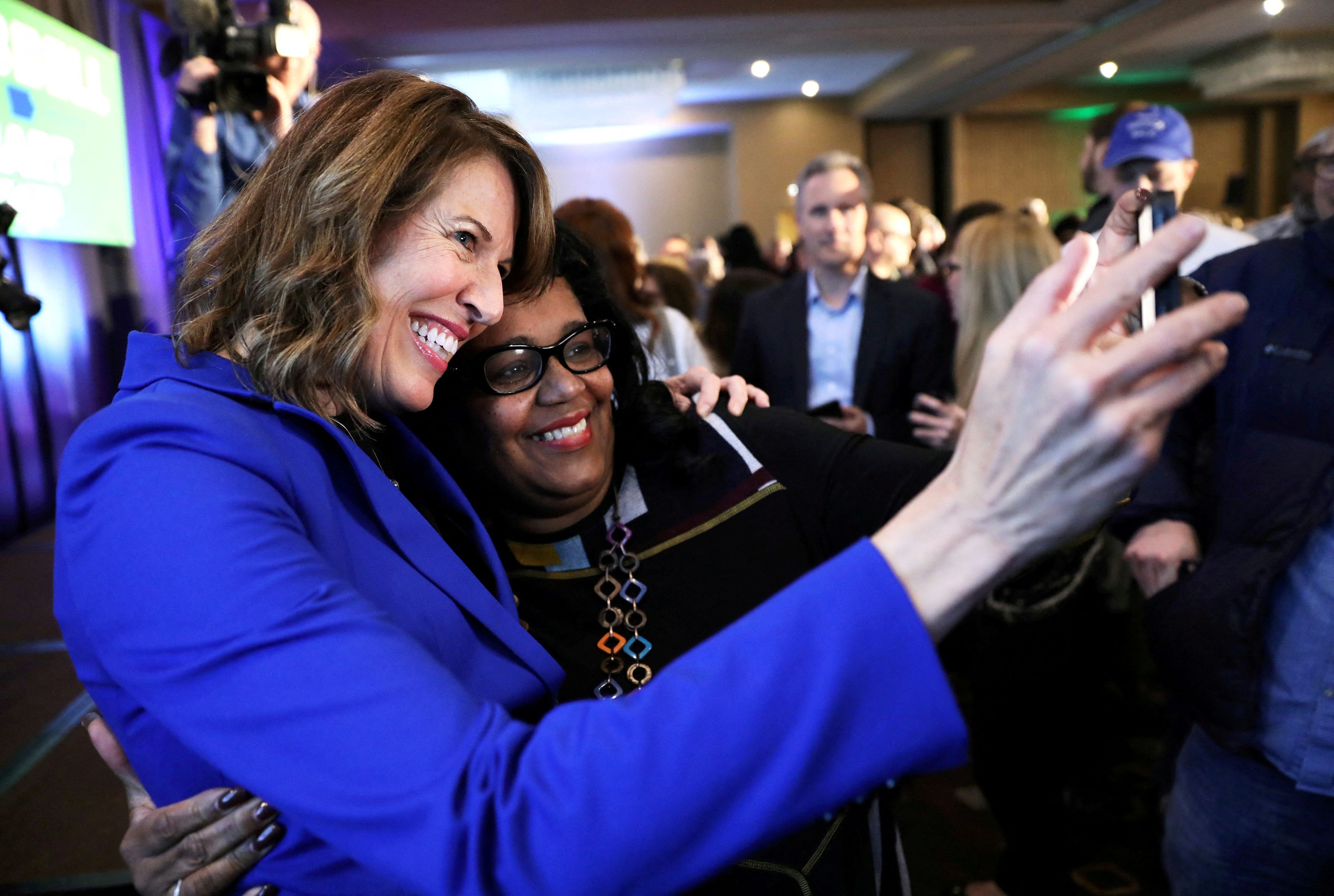 Democratic congressional candidate Cindy Axne, left, takes a photo with West Des Moines City Councilwoman Renee Hardman while appearing at a midterm election night party in Des Moines, Iowa, Nov. 6, 2018.