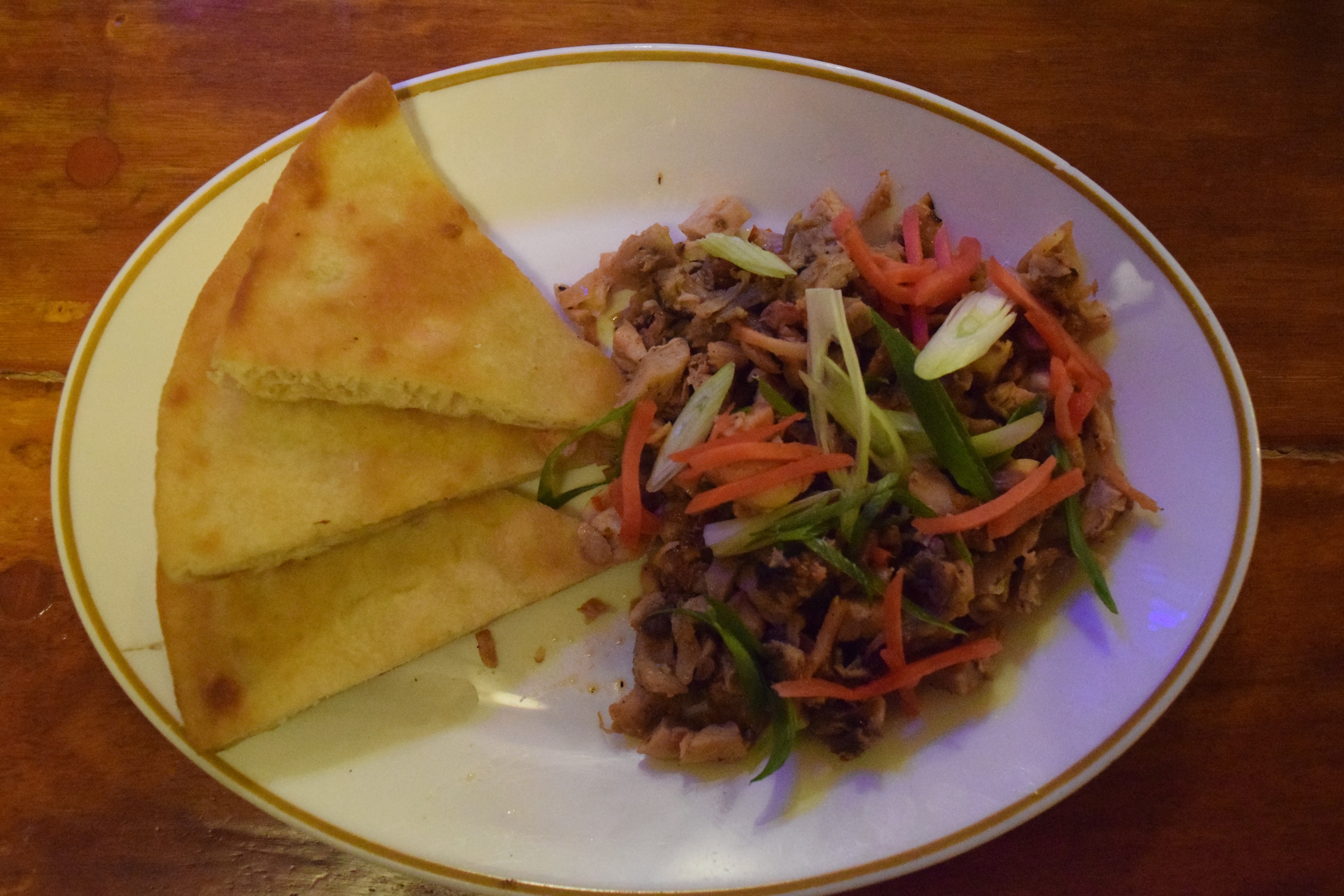 Chicken kelaguen and pita bread, with herbs and spices.