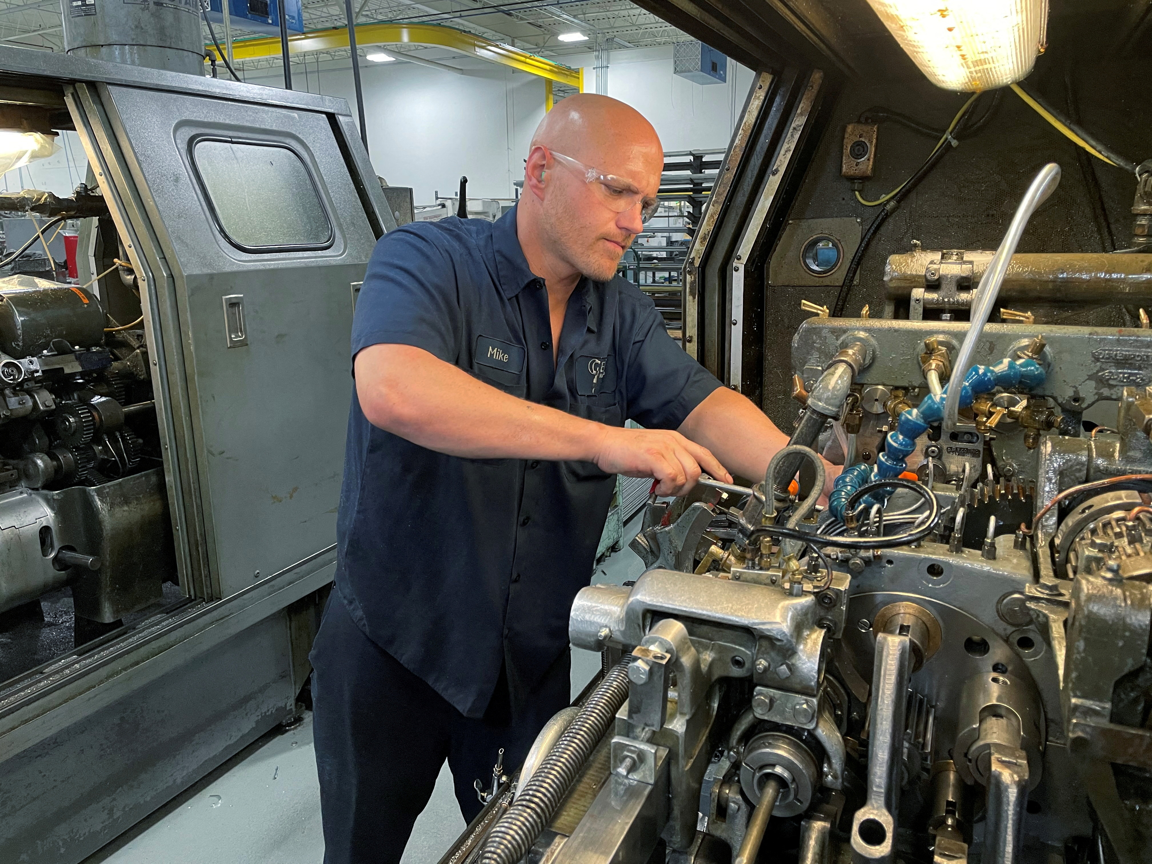 A worker operates one of the metal cutting machines at Gent Machine Co.'s factory in Cleveland, Ohio, May 26, 2021.