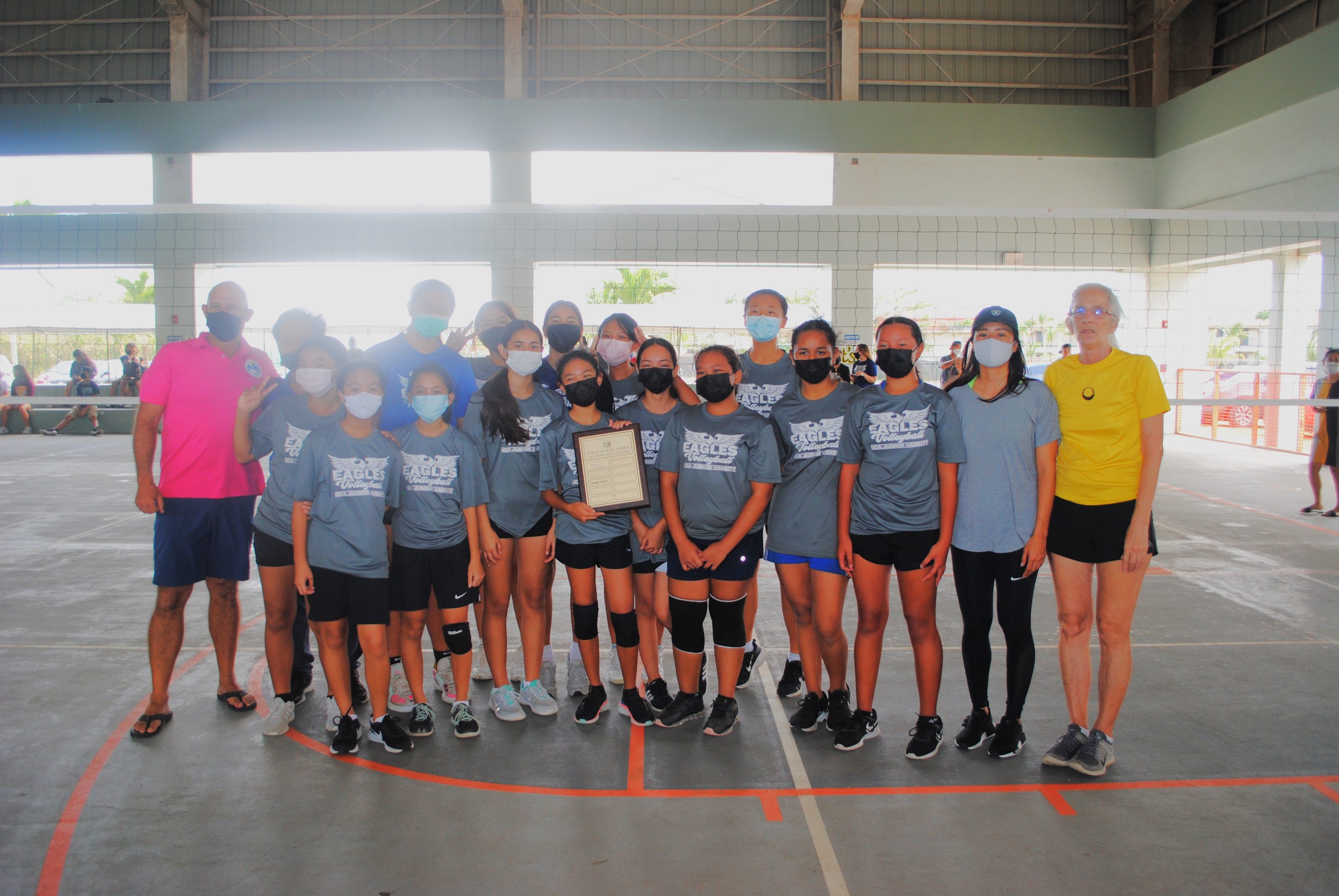 The Grace Christian Academy Eagles pose with the perpetual plaque after winning the PSS Girls Middle School Volleyball championship Saturday at Koblerville gym.