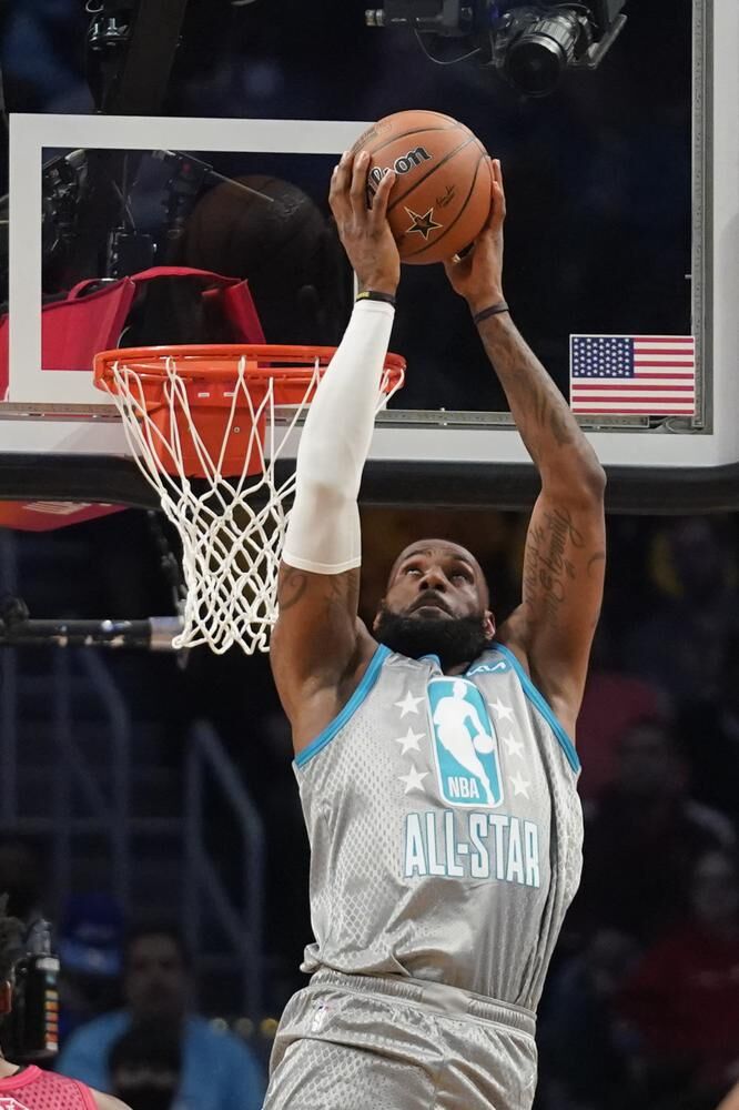 Los Angeles Lakers' LeBron James goes up for a reverse dunk during the first half of the NBA All-Star basketball game, Sunday, in Cleveland.