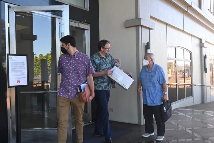 Edwin Caldie, attorney for the Official Committee of Unsecured Creditors, speaks with Leo Tudela, right, who represents clergy sex abuse survivors, as they and co-counsel Andrew Glasnovich exit the federal court Monday in Hagåtña.