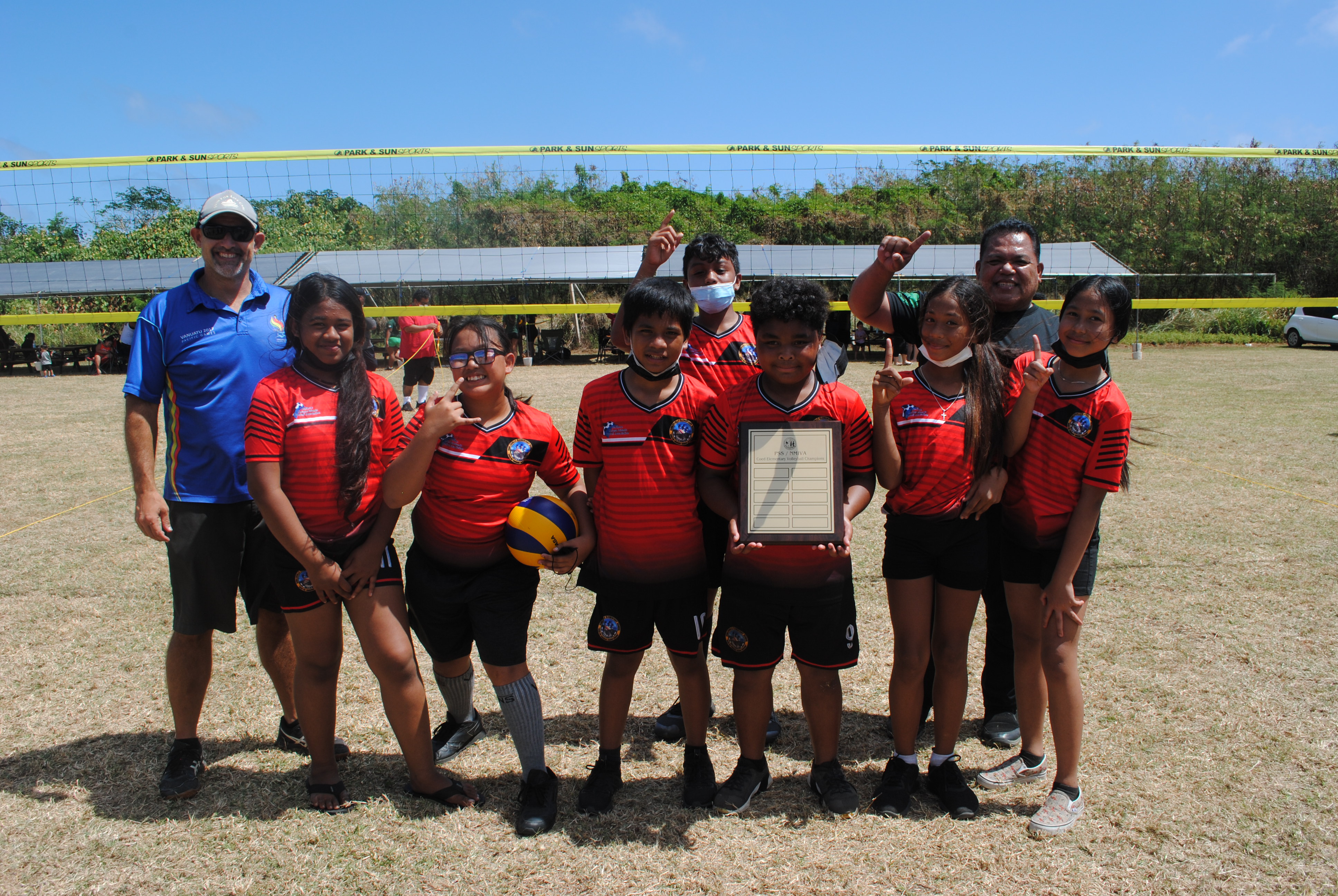 KoES 2 team members pose for a photo with PSS Athletics Program Director Nick Gross after winning the championship game of the co-ed elementary school volleyball tournament Saturday at Chacha Oceanview Middle School field.