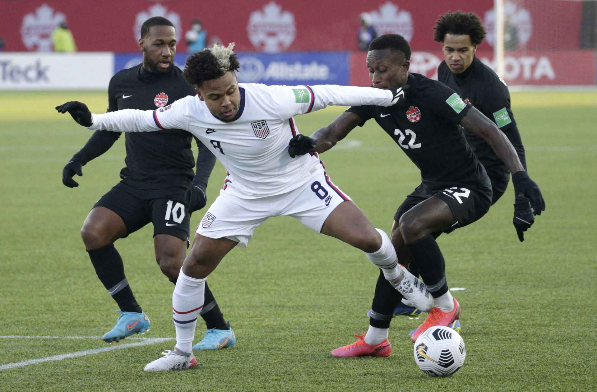 Weston McKennie of the U.S. in action against Canadian defenders  at the Tim Hortons Stadium, Hamilton, Canada on Jan. 30, 2022.