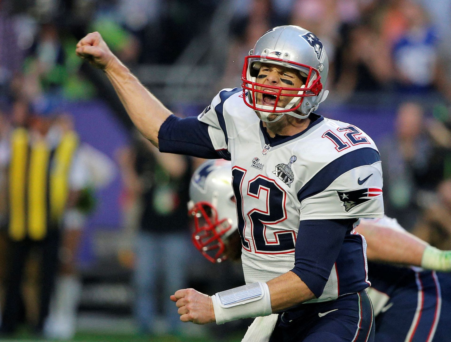 New England Patriots quarterback Tom Brady (12) celebrates his second quarter touchdown pass against the Seattle Seahawks to wide receiver Brandon LaFell during the NFL Super Bowl XLIX football game in Glendale, Arizona on Feb. 1, 2015.