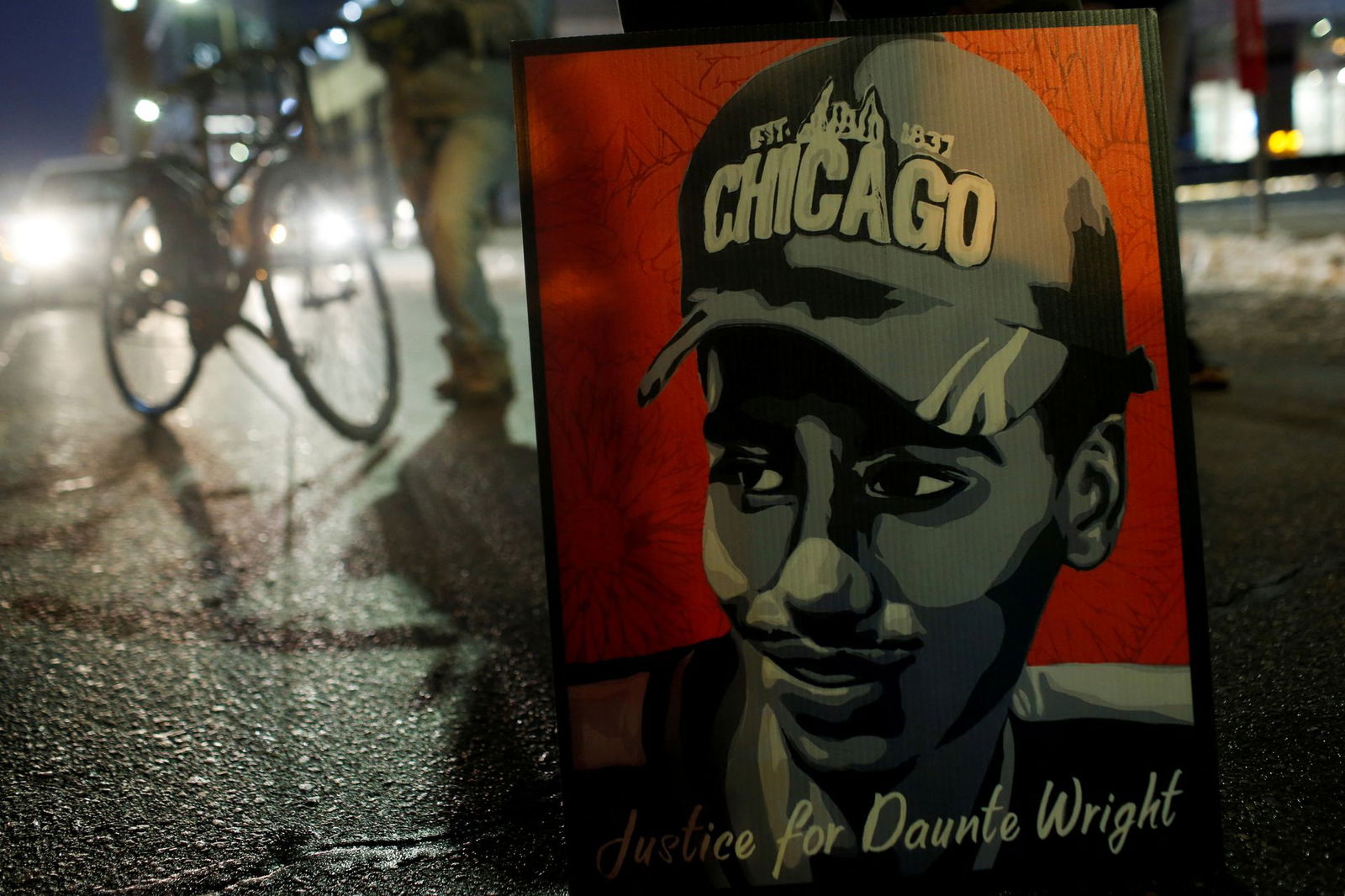 A poster of Daunte Wright is seen during a demonstration after the opening statements in the manslaughter trial of Kimberly Potter, a white former Minnesota police officer charged in the fatal shooting of Daunte Wright, a Black man, whose April death sparked protests, in Minneapolis, Minnesota, Dec. 8, 2021.