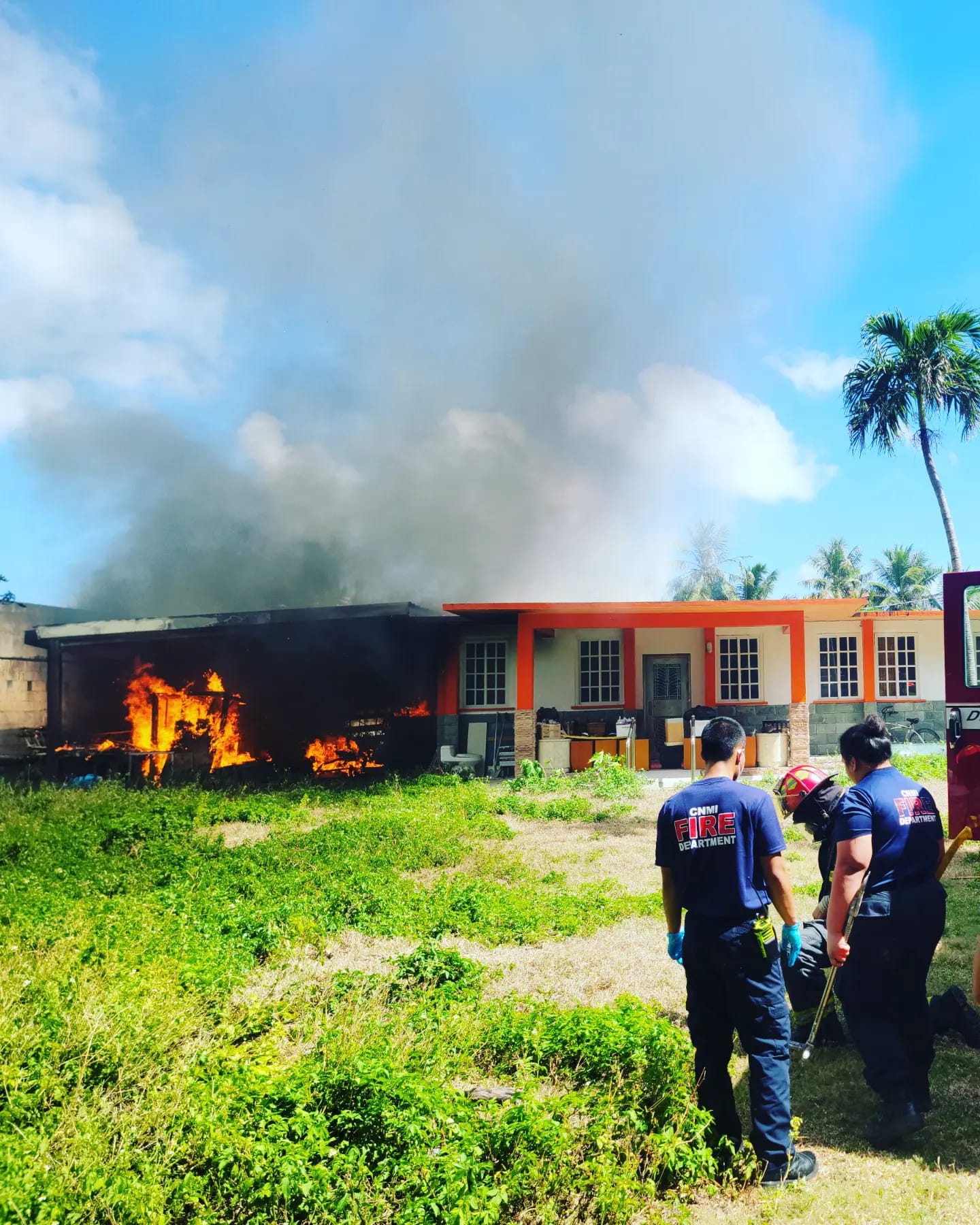 Firefighters respond to a raging fire at a Chalan Kanoa house on Saturday.