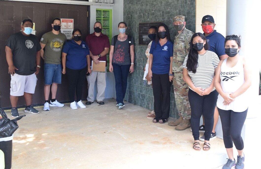 U.S. Army Innovative Readiness Training program manager, Maj. Dan Lavorgna, fourth right, veterinarian Maj. Rick Upshaw, fourth left, other members of the 445th Medical Detachment Veterinary Services Support,  and CNMI Bureau of Military Affairs Special Assistant Glenna Palacios, fifth right, at the Gualo Rai Youth Center on Monday.