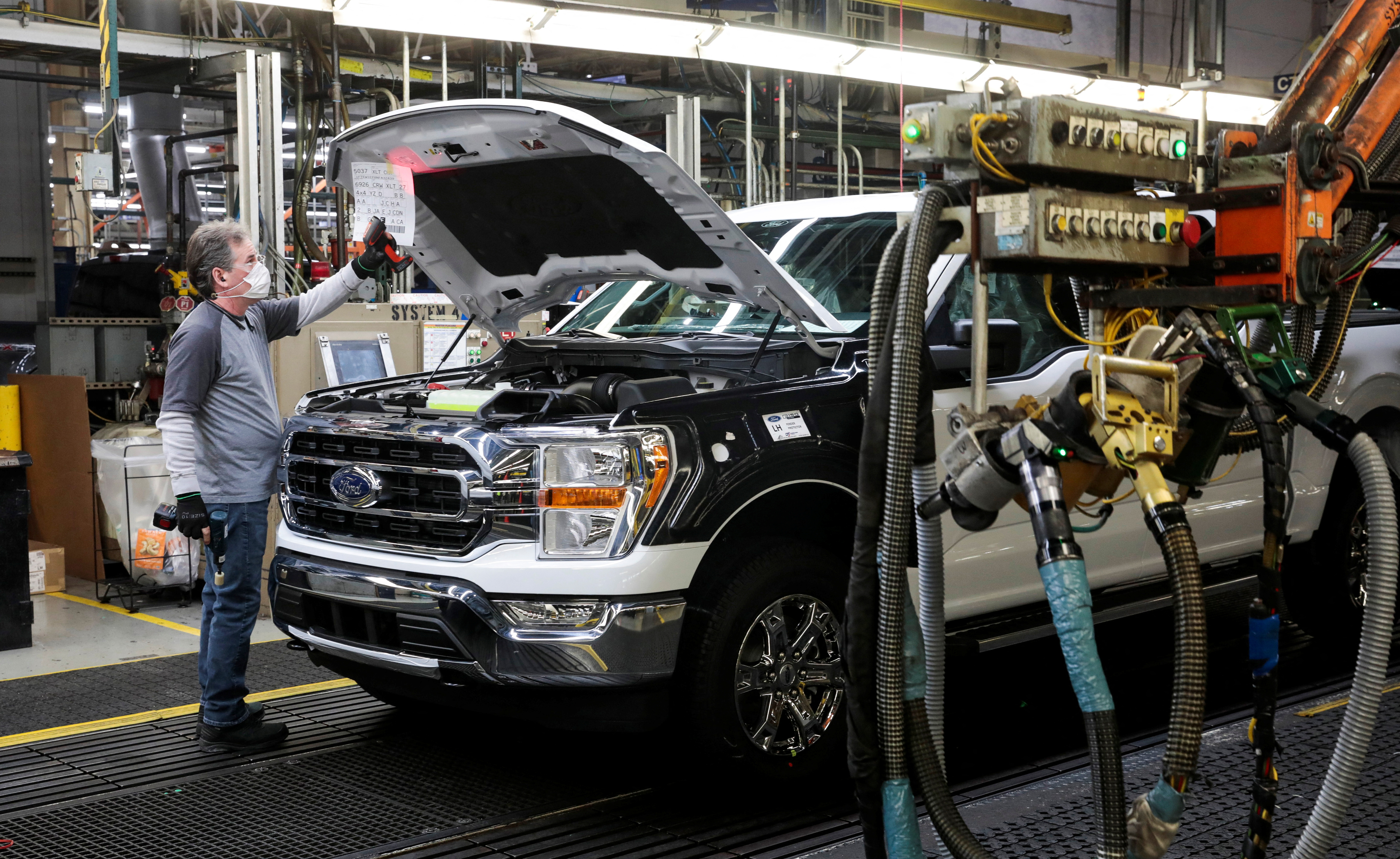 An assembly worker of Ford Motor works on an F-series pickup truck at the Dearborn Truck Plant in Dearborn, Michigan on Jan. 26, 2022.