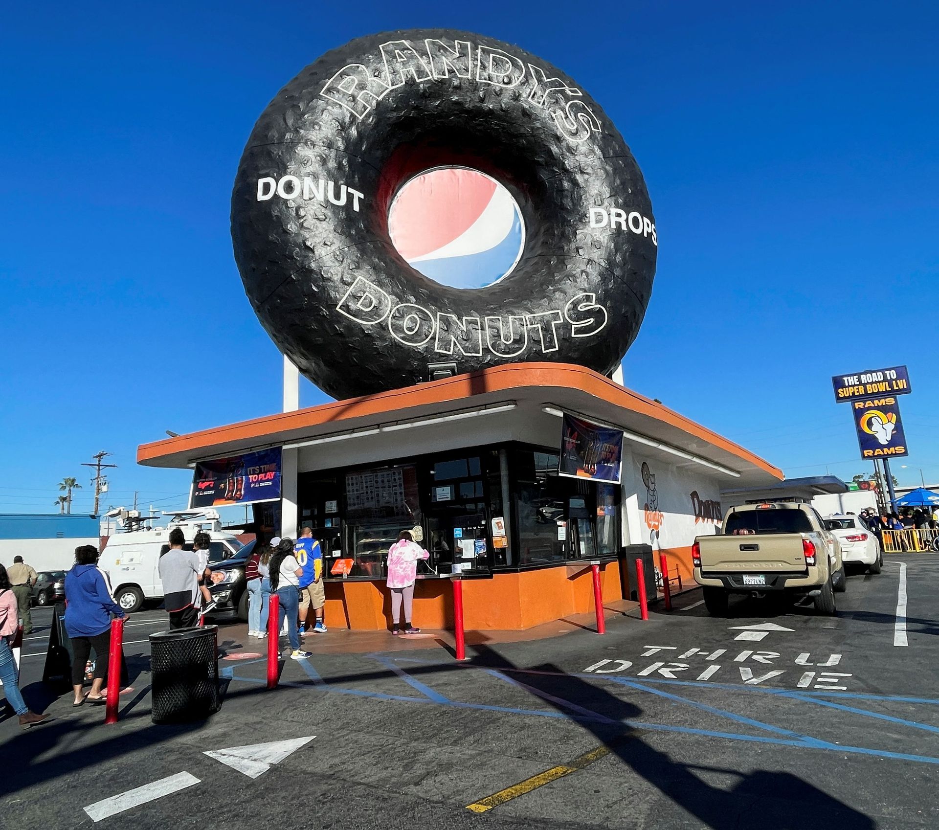People line up to buy Los Angeles Rams themed donuts at Randy's Donuts, near the venue for Sunday's Super Bowl, in Inglewood, California, Feb. 11, 2022.