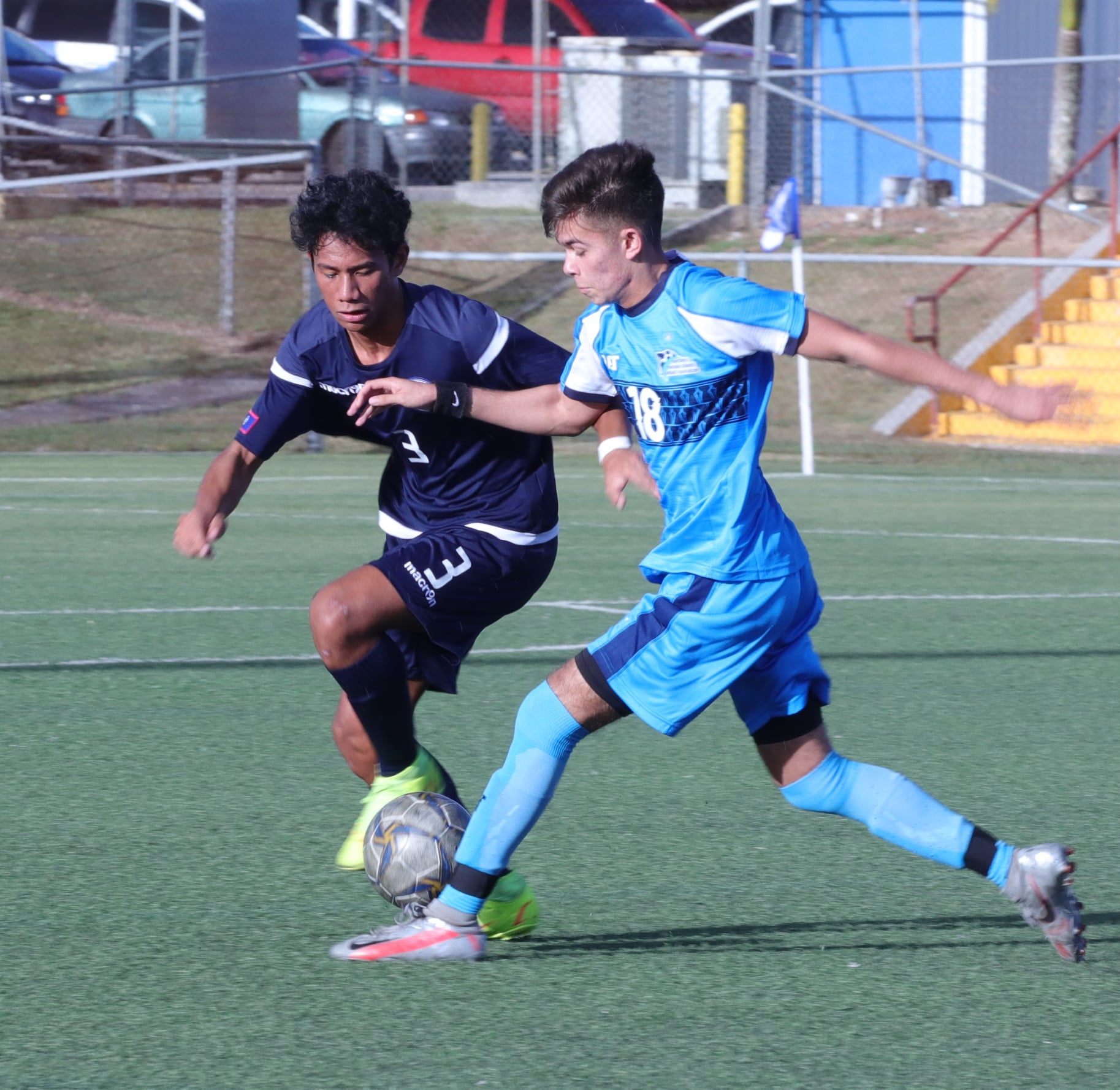 NMI men’s U20 team member Richard Steele races against a Guam defender during a friendly match Saturday at the Guam Football Association National Training Center in Dededo.
