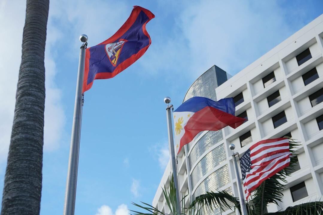 The Philippine flag flies between those of Guam and the U.S. during the 121st anniversary of the Proclamation of Philippine Independence at the Guam Reef Hotel in Tumon on June 12, 2019.
