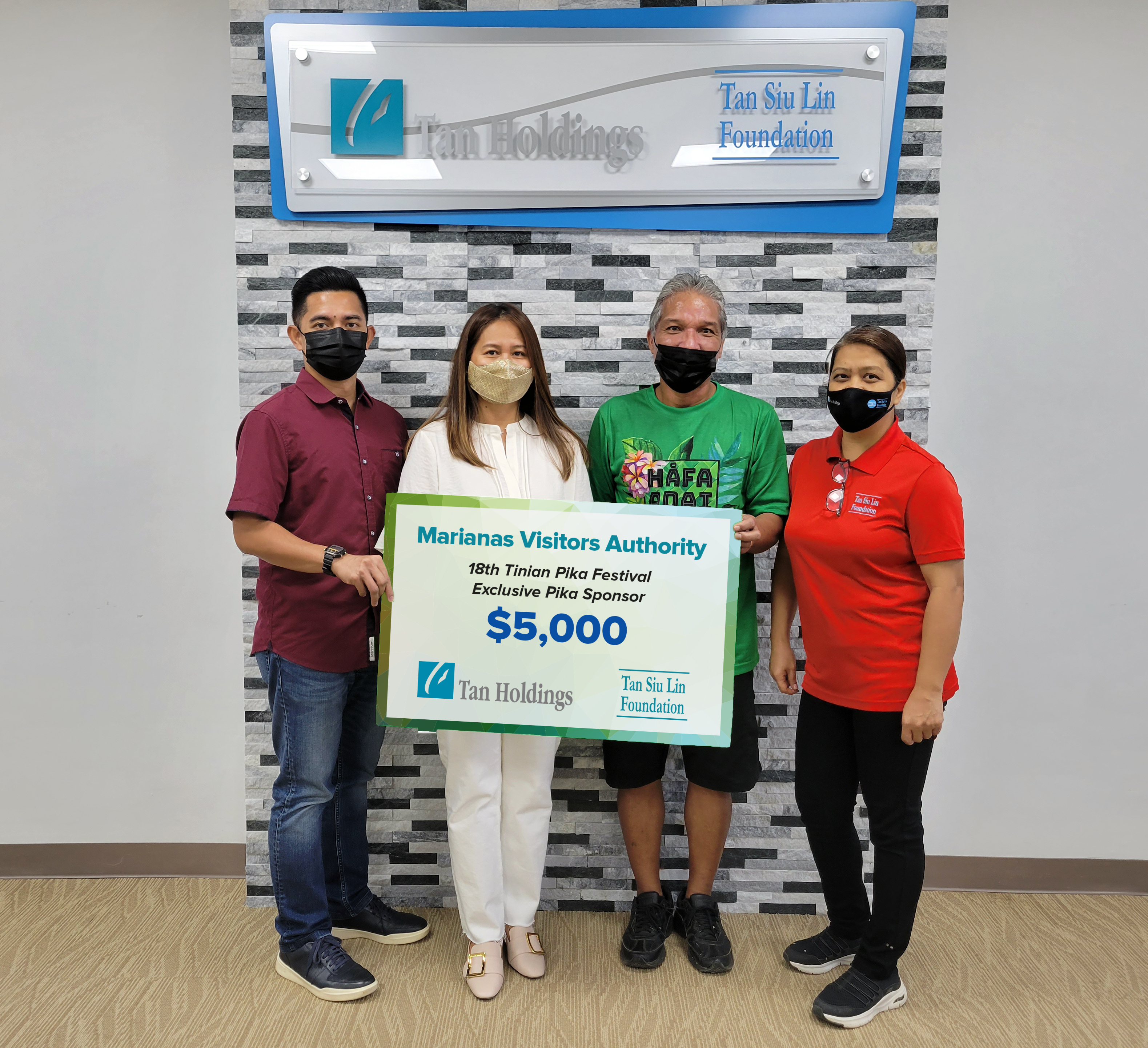Marianas Visitors Authority Community Projects specialist Ray Villagomez, third left, receives a ceremonial check donation for the 18th Annual Tinian Pika Festival from Tan Siu Lin Foundation executive director Merlie Tolentino, second left, assistant manager Raymond Zapanta, left, and administrative officer Rina Robles, right, Monday in the TanHoldings conference room in Garapan.