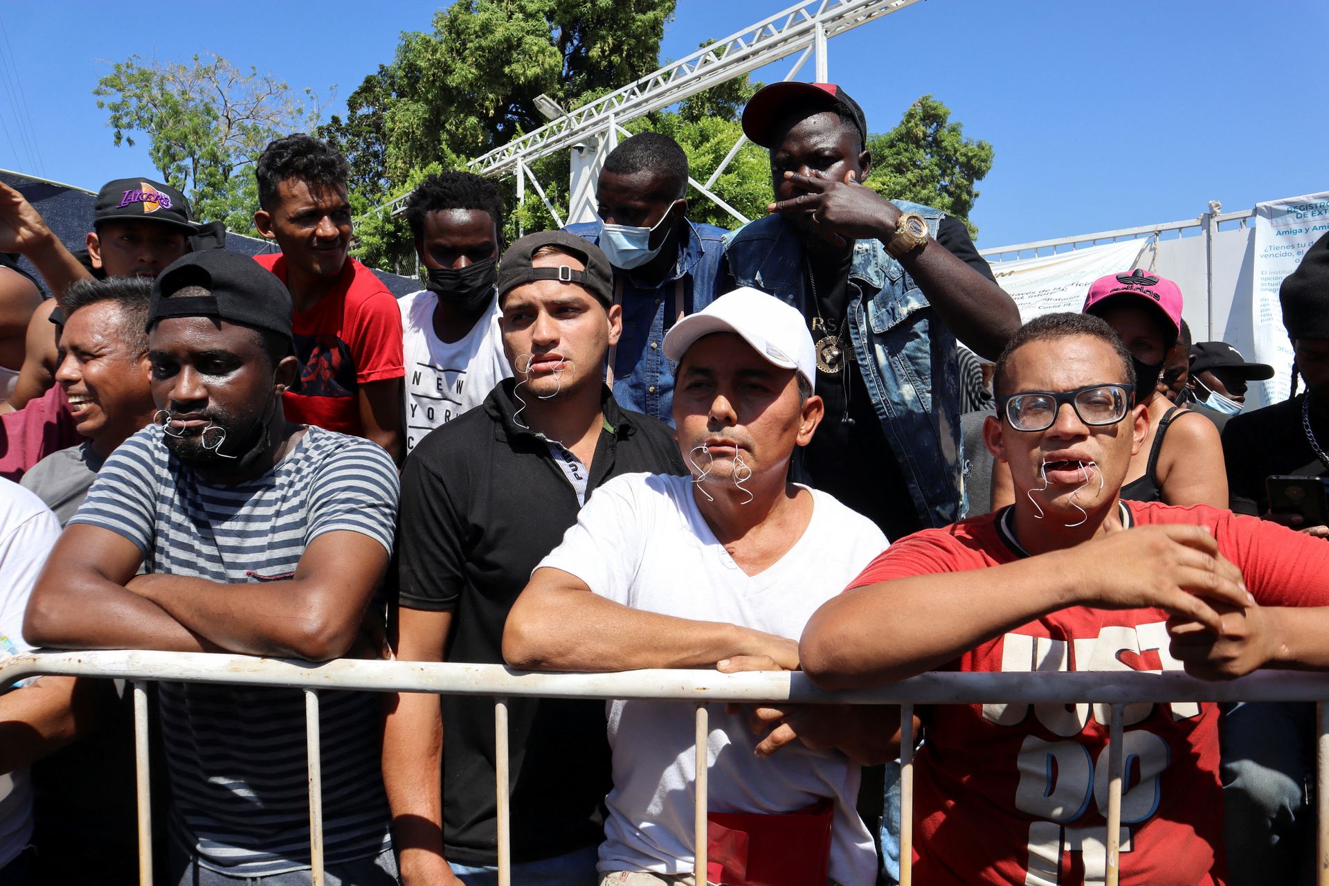 Migrants begin a hunger strike with their mouths sewed shut during a protest to demand free transit through the country outside the office of the National Migration Institute in Tapachula, Mexico, Feb. 15, 2022.