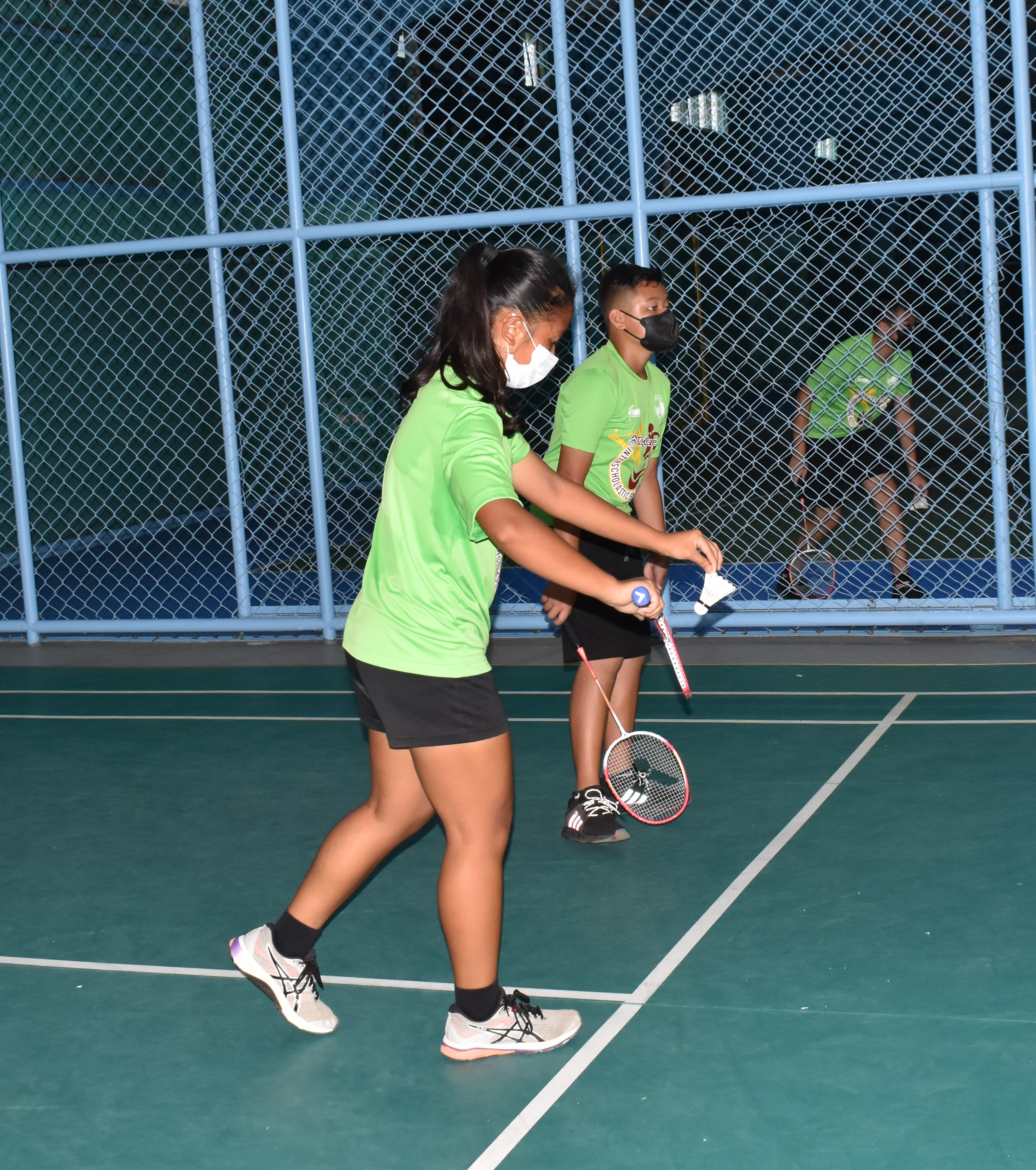 An SIS player gets ready for the serve during one of the opening games of the TakeCare Interscholastic Middle School Badminton League at the TSL Sports Complex.