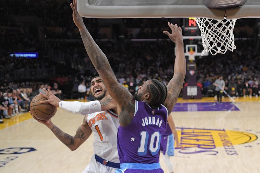 New York Knicks forward Obi Toppin, left, snoots as Los Angeles Lakers center DeAndre Jordan defends during the first half of an NBA basketball game Saturday in Los Angeles. 