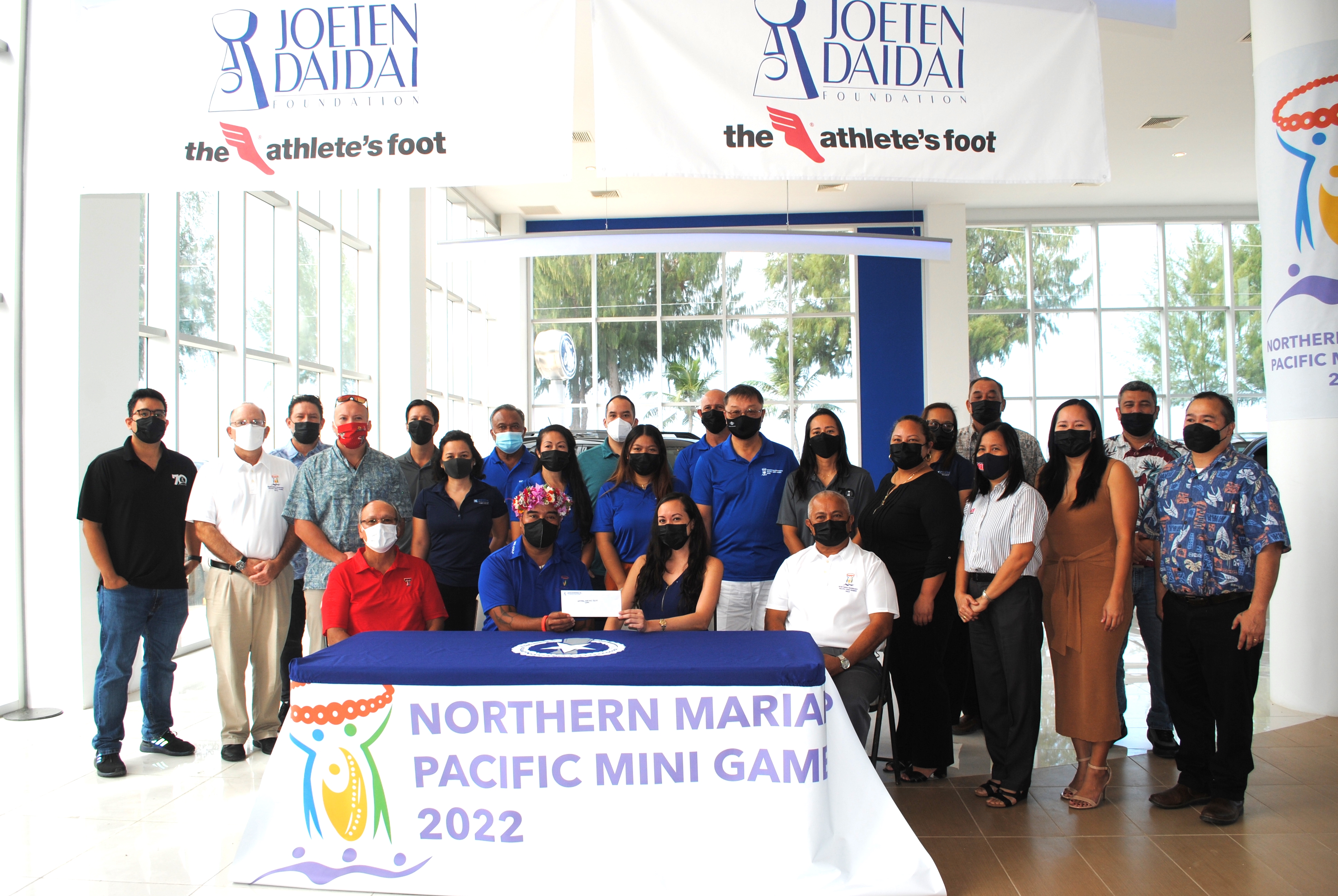 Joeten Daidai Foundation officers pose for a photo with 2022 Pacific Mini Games organizers, local sports and other officials in the Joeten Motors showroom Thursday.