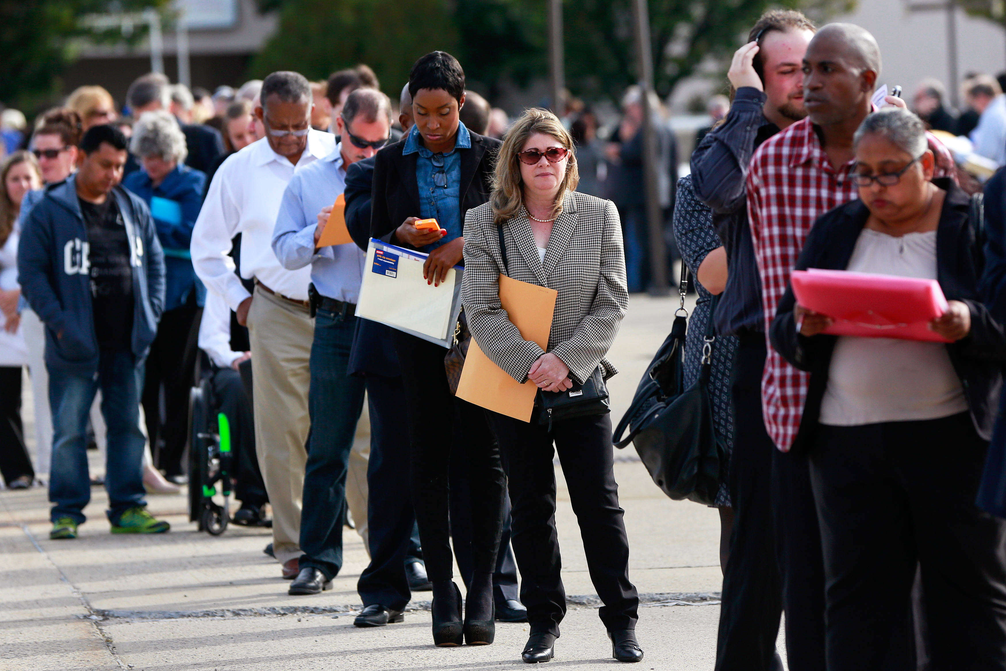People wait in line to enter the Nassau County Mega Job Fair at Nassau Veterans Memorial Coliseum in Uniondale, New York, Oct. 7, 2014.